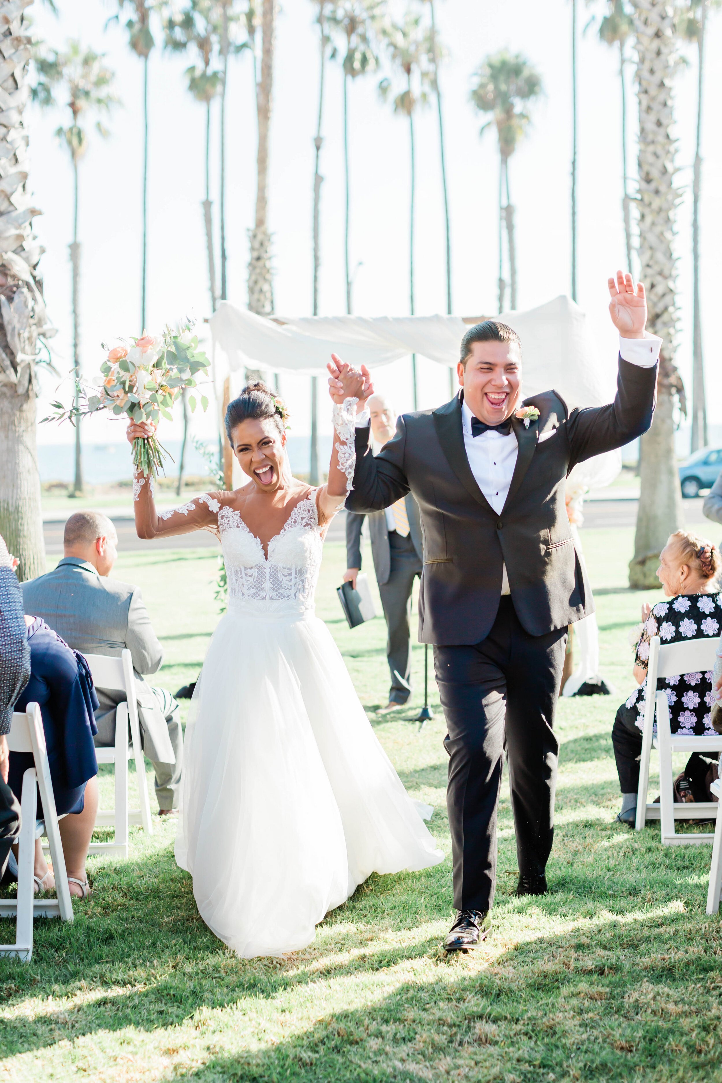 www.santabarbarawedding.com | White Sage Wedding &amp; Events | Amber Jean | Hilton SB Beachfront Resort | Ojai Blooms | Amigo Party Rentals | Brendan Gallagher | Couple Leaving the Ceremony