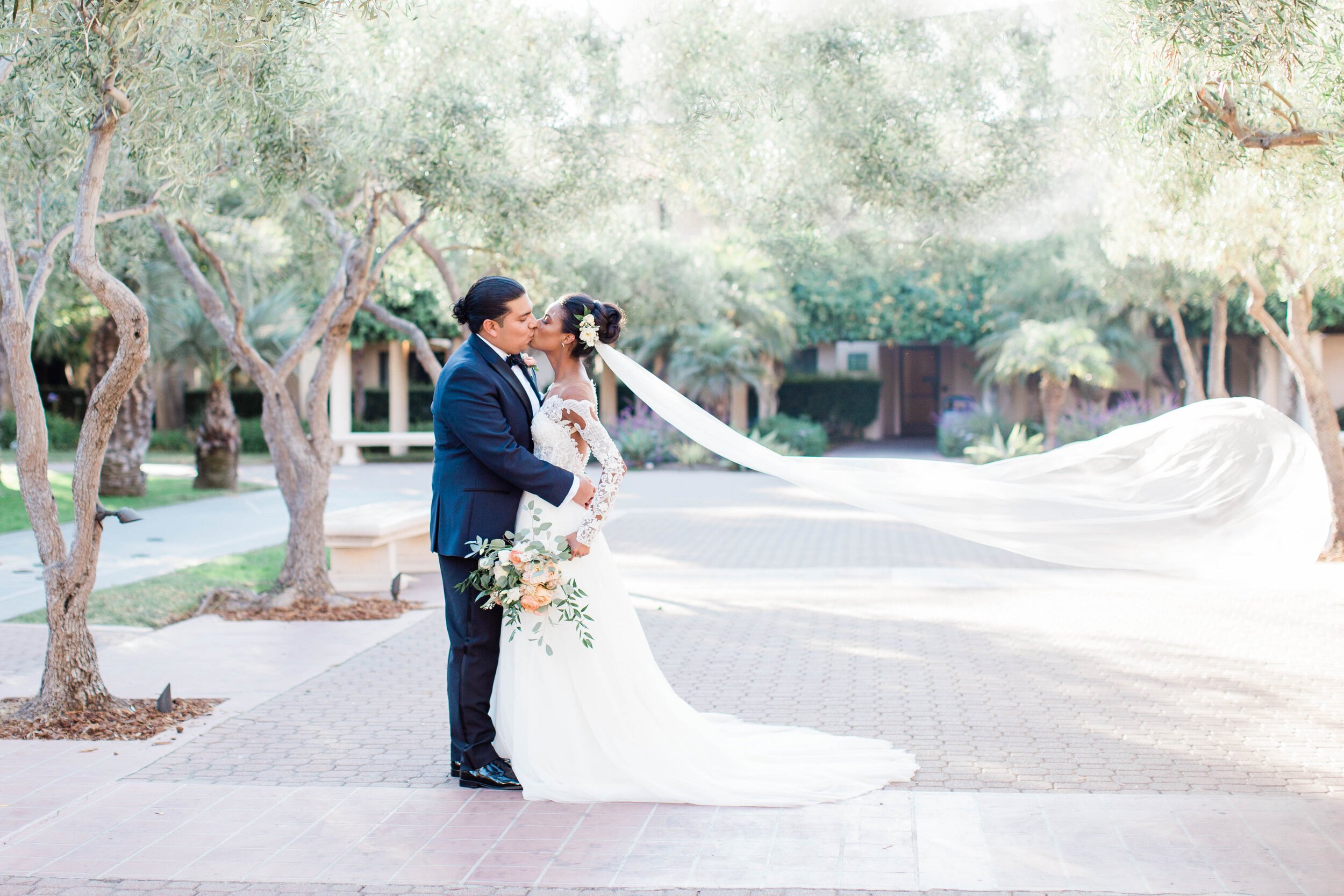 www.santabarbarawedding.com | White Sage Wedding &amp; Events | Amber Jean | Hilton SB Beachfront Resort | Ojai Blooms | Rogue Styling | Anomalie | Bride and Groom Share a Kiss