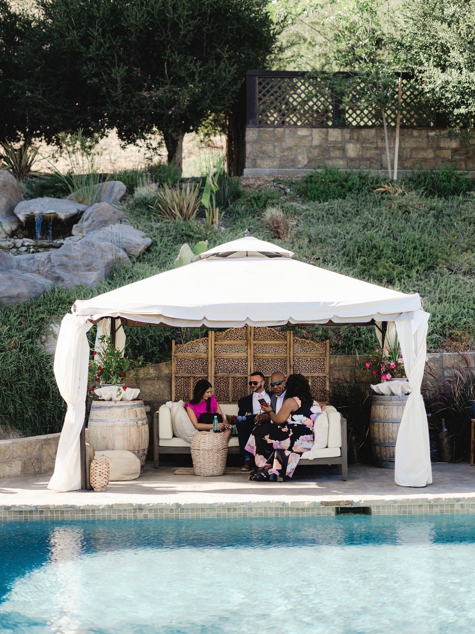 www.santabarbarawedding.com | Zaca Creek | Paul Von Rieter | Lisa Lafferty Events | Glenna Joy Flowers | Theoni Collection | Guest Sitting Under a Tent by the Pool