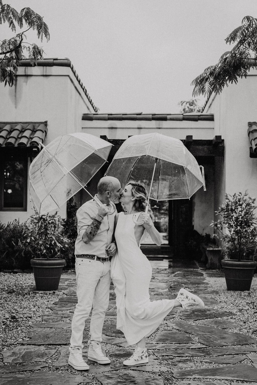 www.santabarbarawedding.com | White Sage Wedding &amp; Events | Matt + Jess | Ojala Floral | Bride and Groom In the Rain with Umbrellas