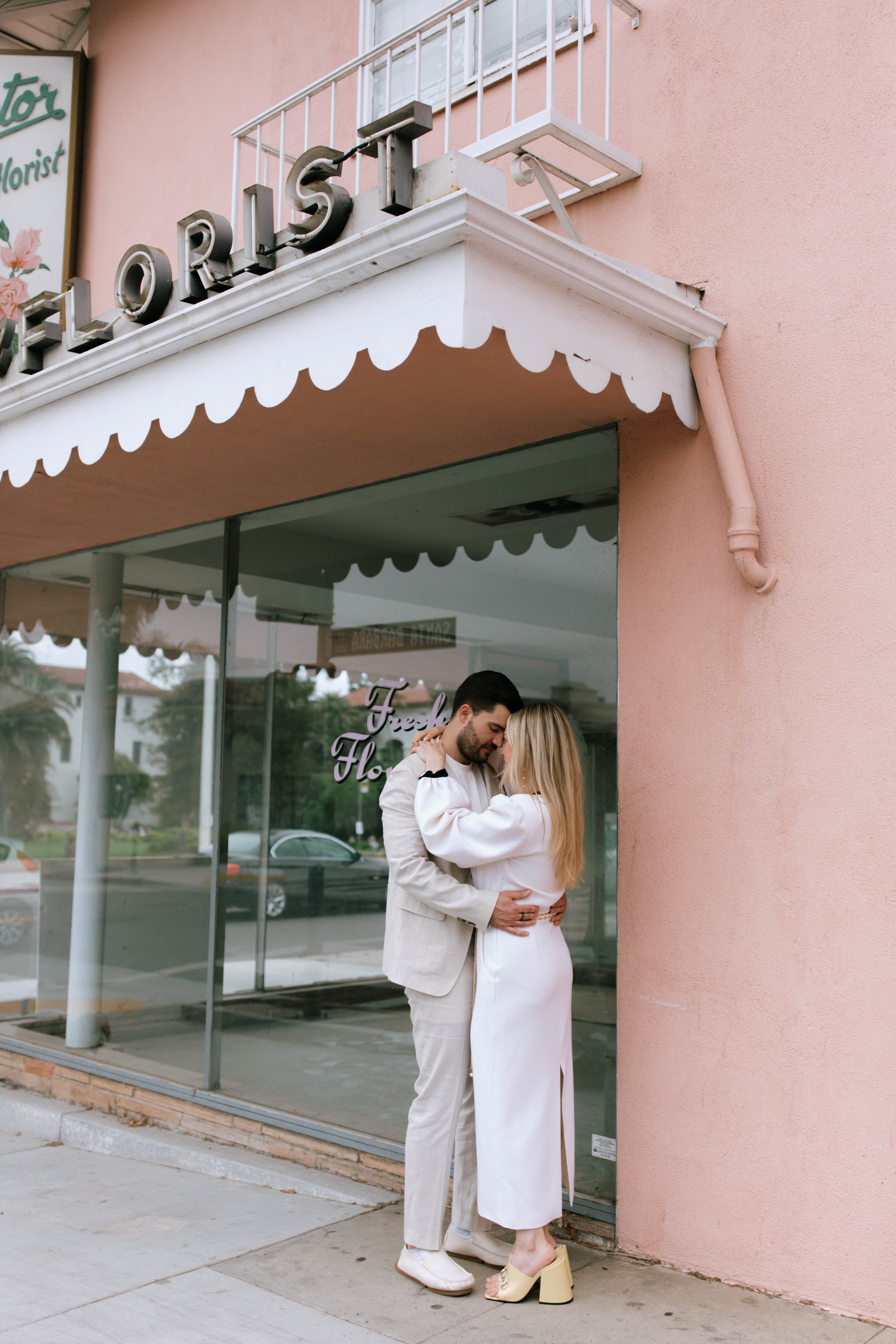 www.santabarbarawedding.com | Monique Bianca Photography | Downtown Santa Barbara | Valentino | Rowen Rose | The Engaged Couple In Front of a Pink Wall