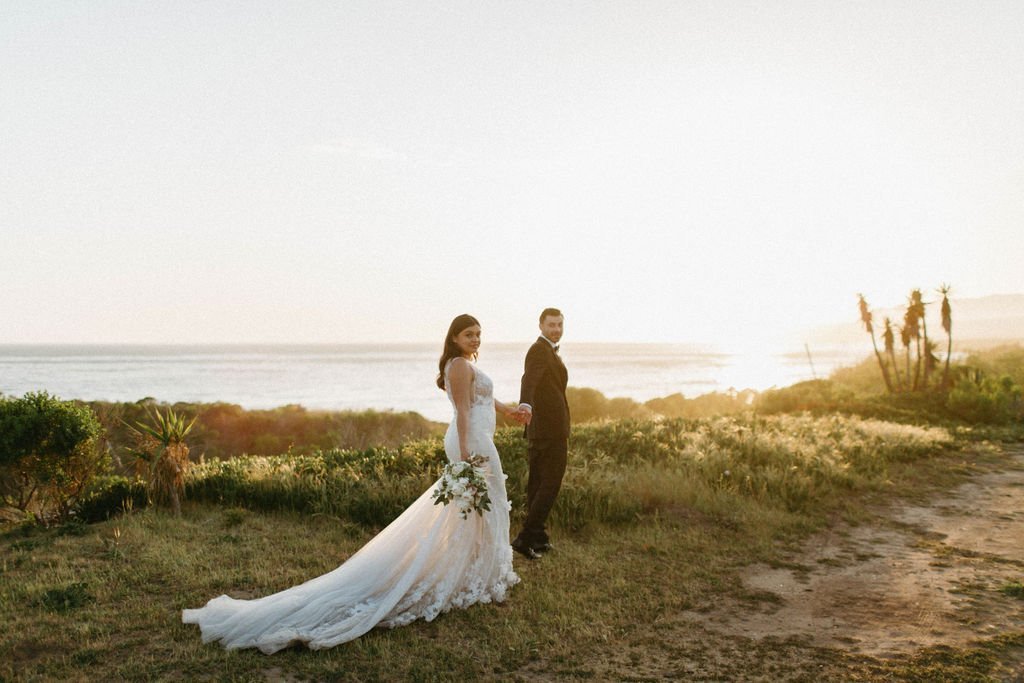 www.santabarbarawedding.com | Dos Pueblos Orchid Farm | Monique Bianca | White Sage | Intrepid Floral Co. | Enzoani | Generation Tux | Couple at Sunset with Ocean Behind Them