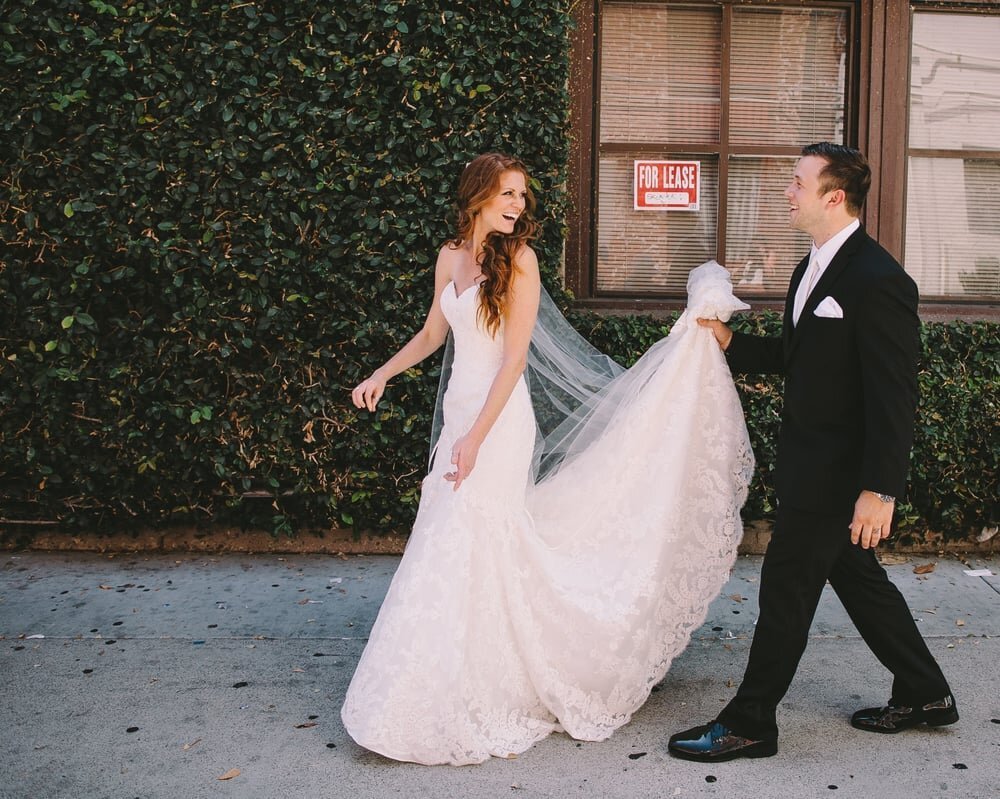 www.santabarbarawedding.com | Ana Maria’s Bridal Boutique | Ryan Vermilion Photography | Groom Carrying Bride’s Dress Train