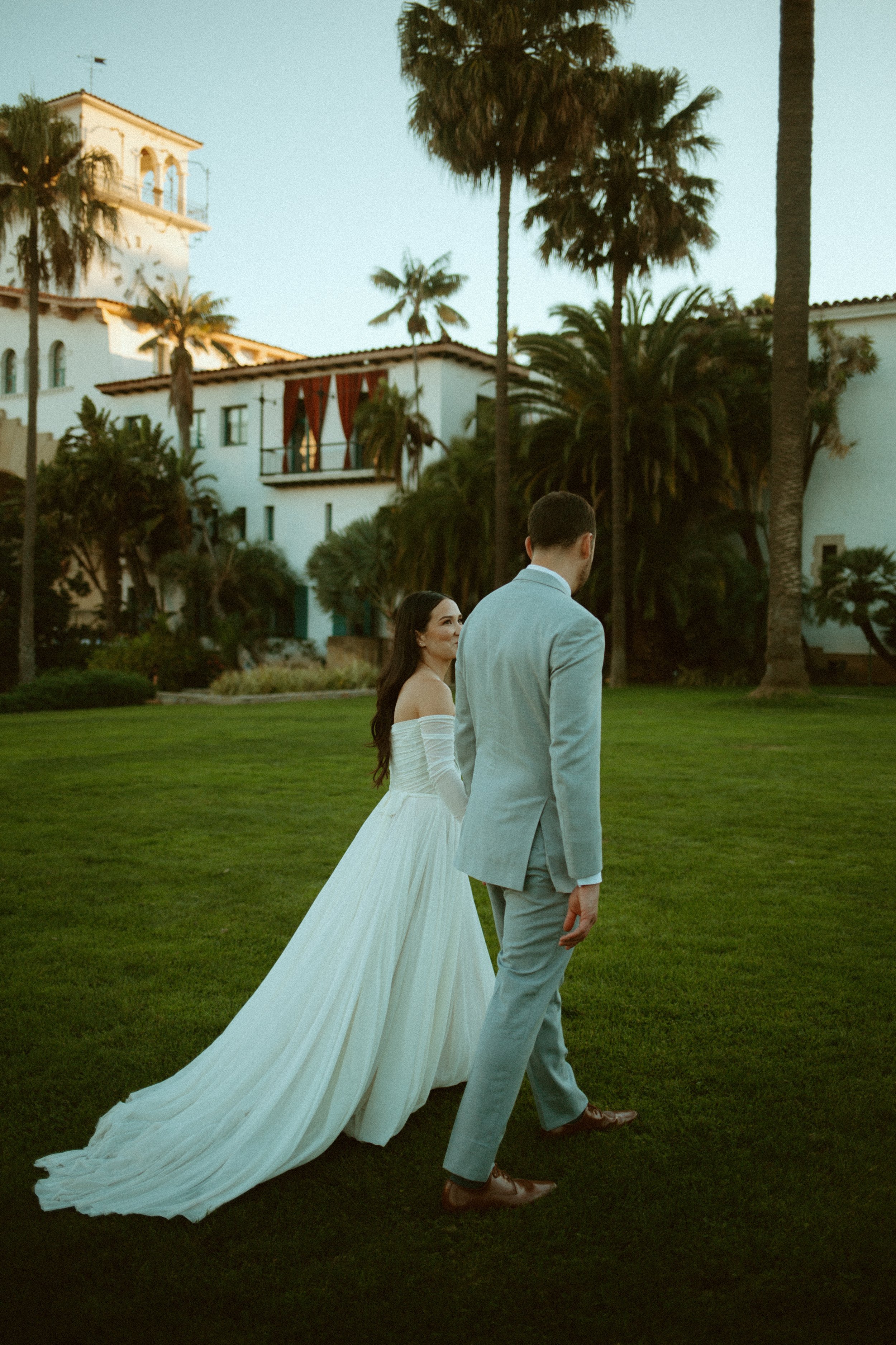 www.santabarbarawedding.com | Mallory Carlson | Santa Barbara Club | Events by Tiffany J | Antheia Floral &amp; Design | BHLDN | Men’s Wearhouse | Bride and Groom Walking on the Lawn