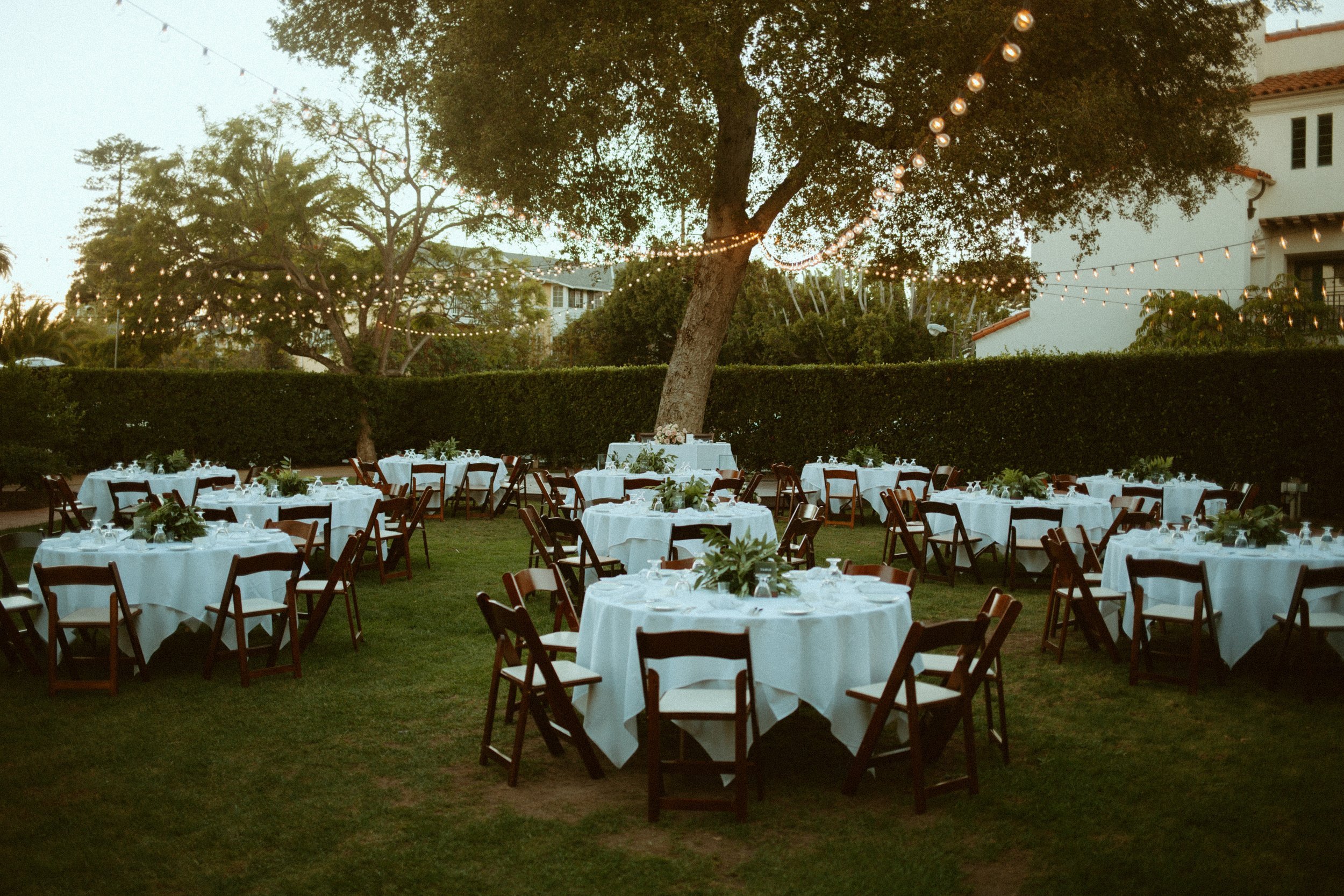 www.santabarbarawedding.com | Mallory Carlson | Santa Barbara Club | Events by Tiffany J | Antheia Floral &amp; Design | Reception Tables Under String Lights