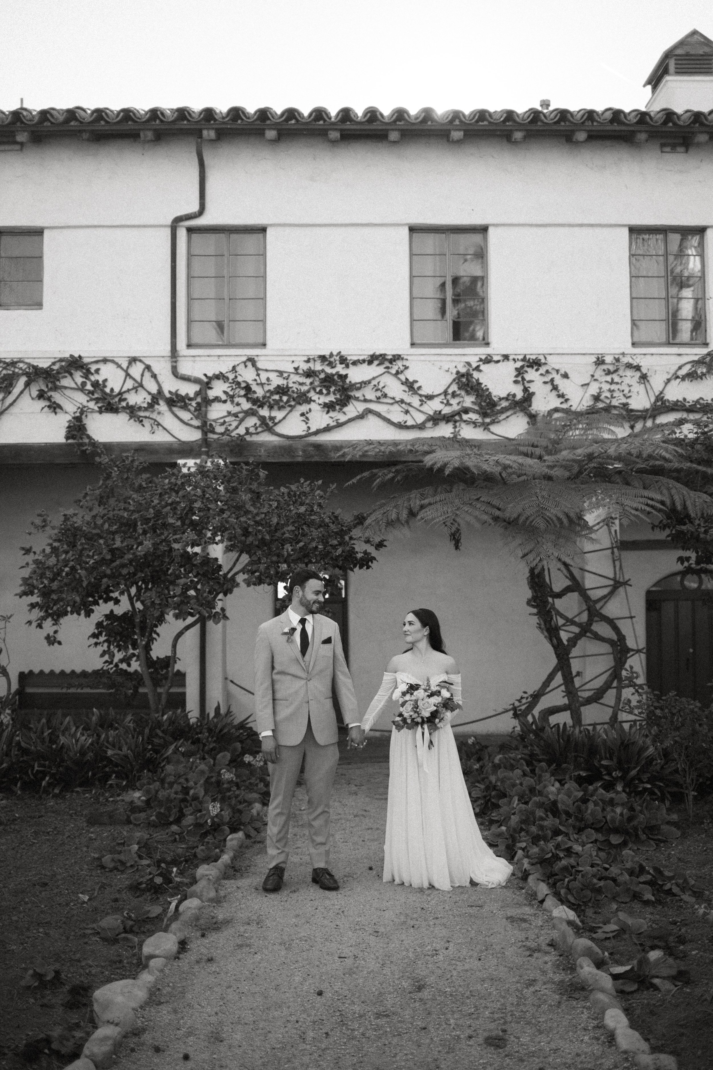 www.santabarbarawedding.com | Mallory Carlson | Santa Barbara Club | Events by Tiffany J | Antheia Floral &amp; Design | BHLDN | Men’s Wearhouse | Bride and Groom Holding Hands Outside