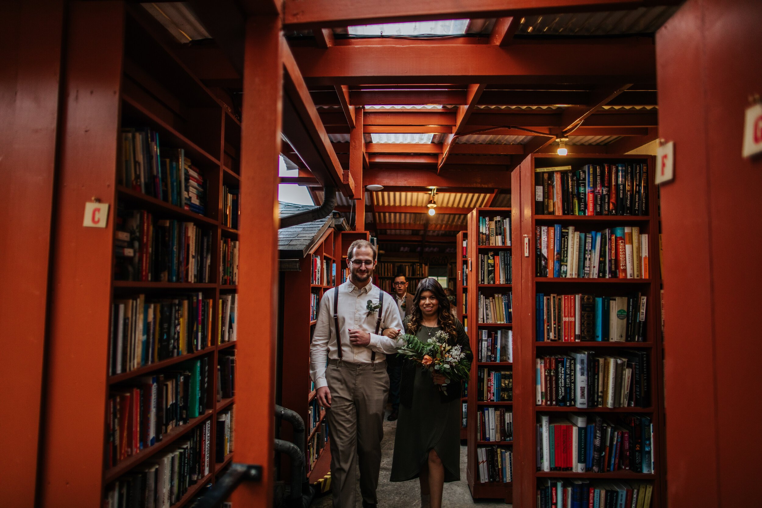www.santabarbarawedding.com | Bart’s Books | Lorie Chambless Photography | Forage Ojai | Chokethai | Rise Ojai | Best Man and Maid of Honor Walking Into Book Store
