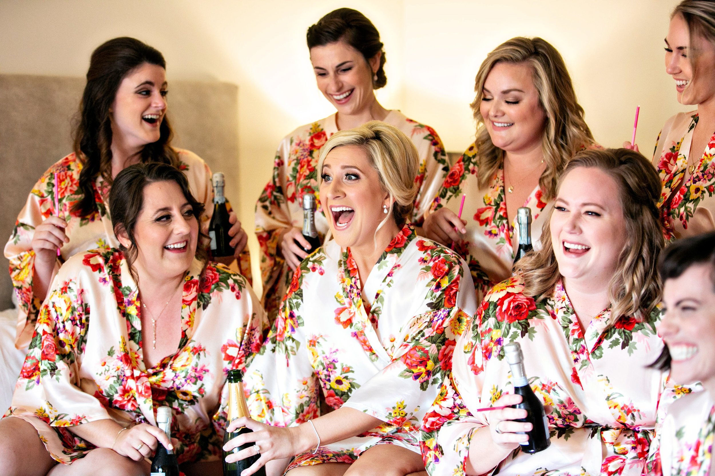 www.santabarbarawedding.com | Laurie Bailey Photography | Bride and Bridesmaids Popping Champagne in Their Robes with Makeup Already Done