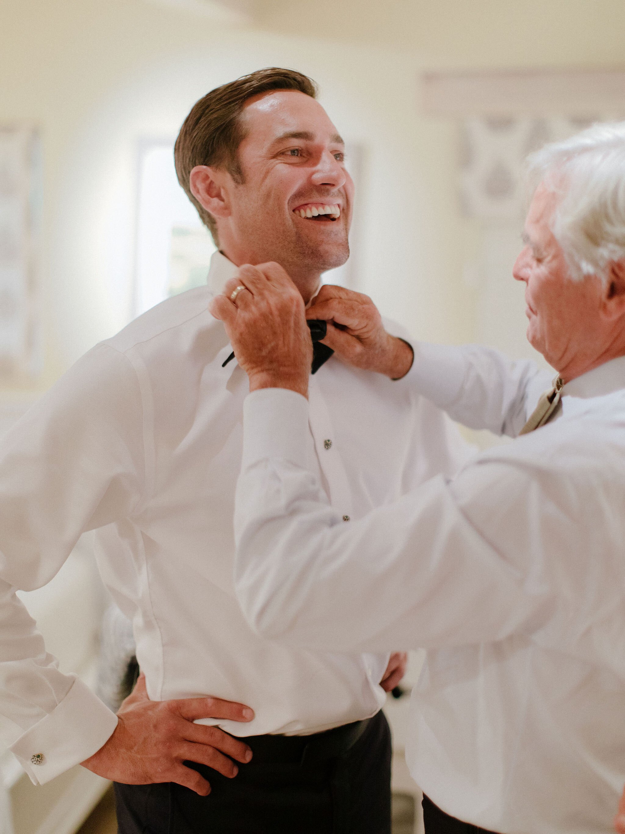 www.santabarbaraweddings.com | Chris J. Evans | Private Residence | Ashley Chanel Events | Rogue &amp; Fox | Groom’s Dad Helping Him with His Bowtie