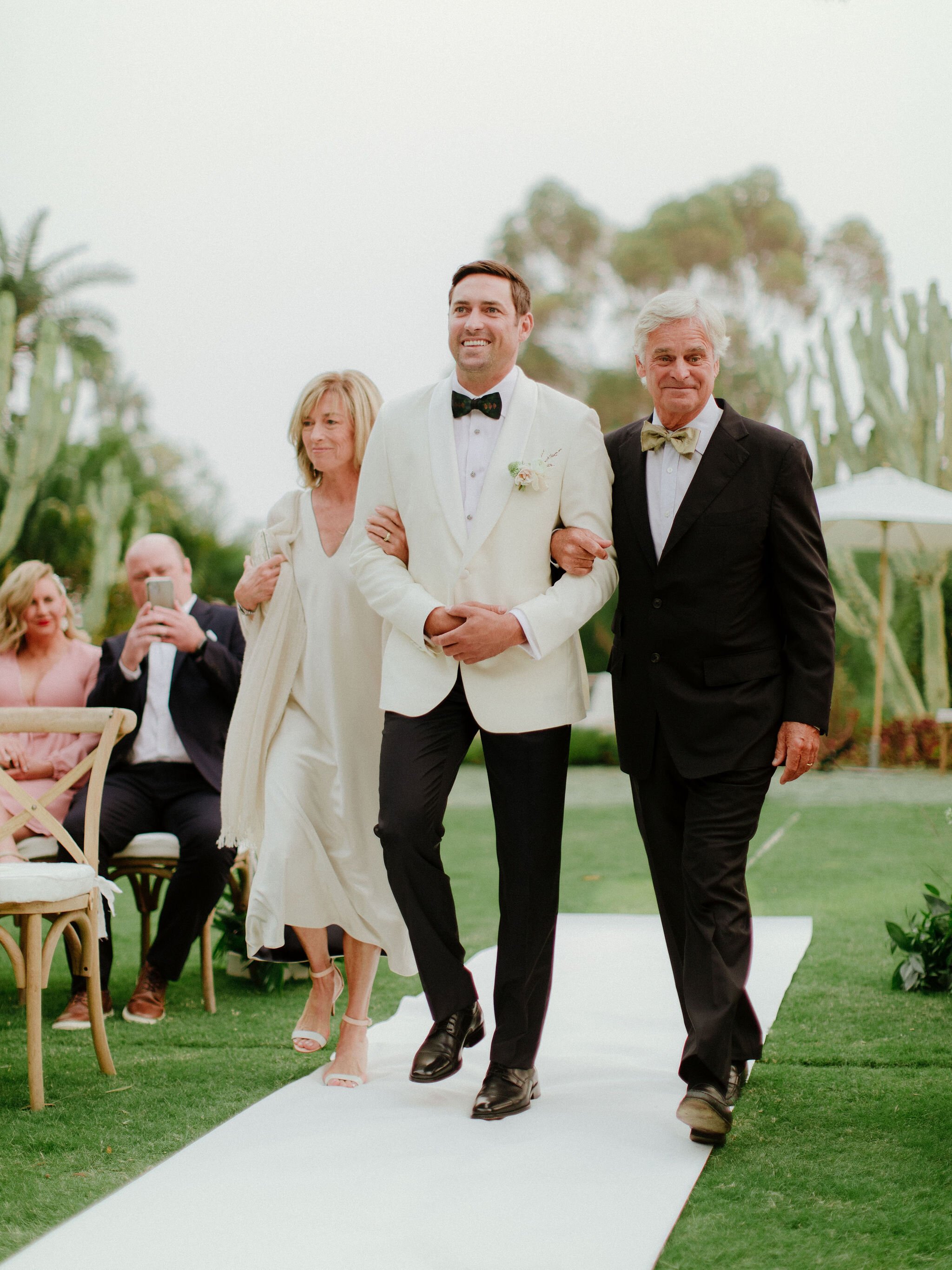 www.santabarbaraweddings.com | Chris J. Evans | Private Residence | Ashley Chanel Events | Rogue &amp; Fox | Groom Walking Down the Aisle with His Parents