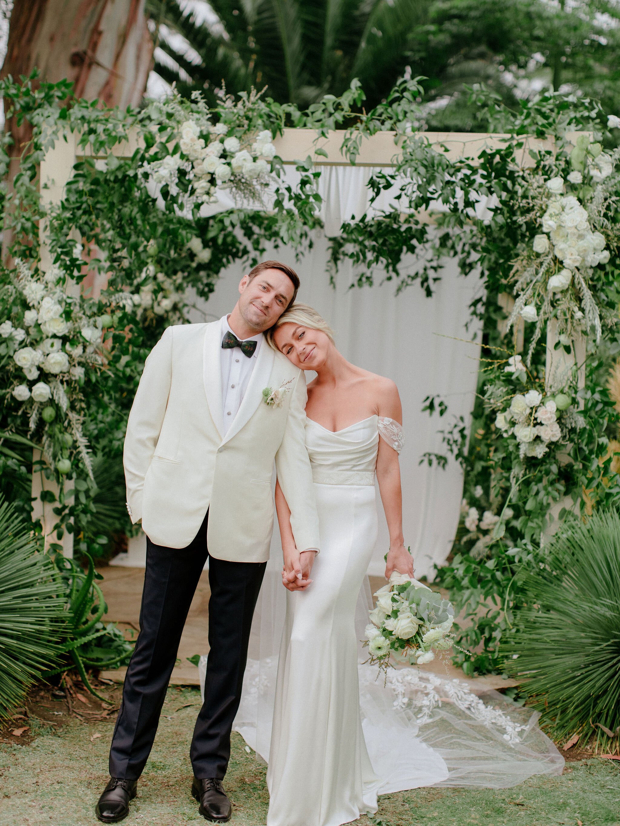 www.santabarbaraweddings.com | Chris J. Evans | Private Residence | Ashley Chanel Events | Rogue &amp; Fox | The Makeup Papi | Bride and Groom in Front of Wedding Arch 