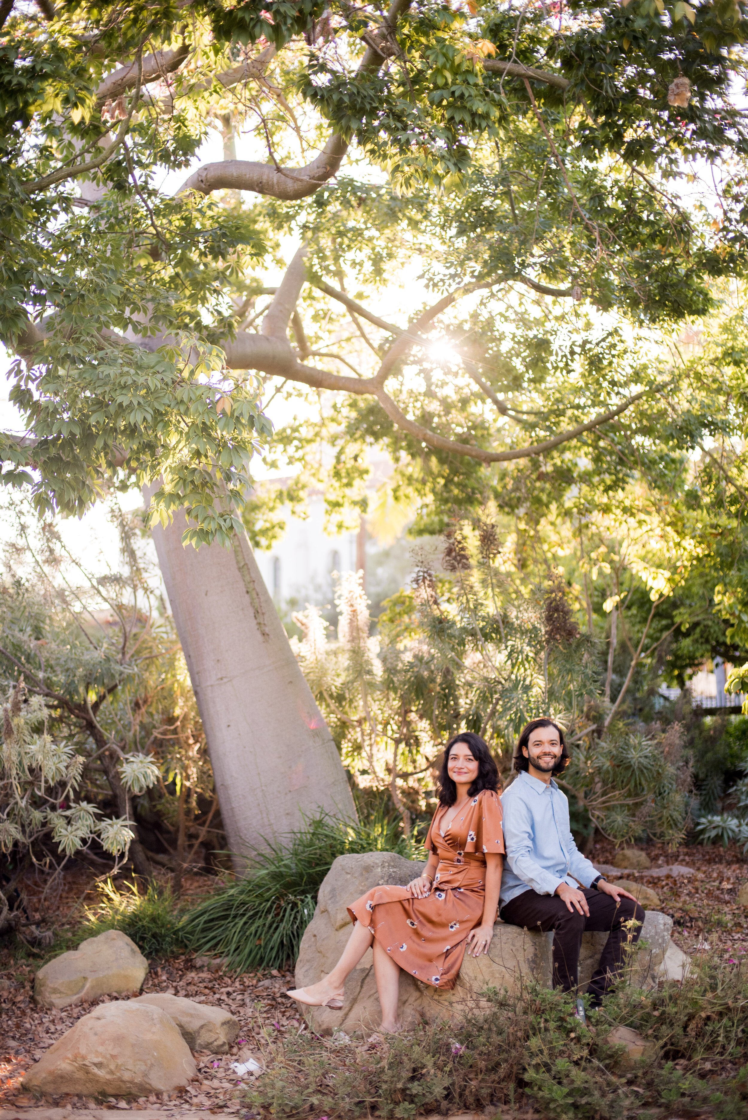 www.santabarbarawedding.com | ByCherry Photography | Alice Keck Park Memorial Garden | Couple Sitting on a Rock Together in the Garden