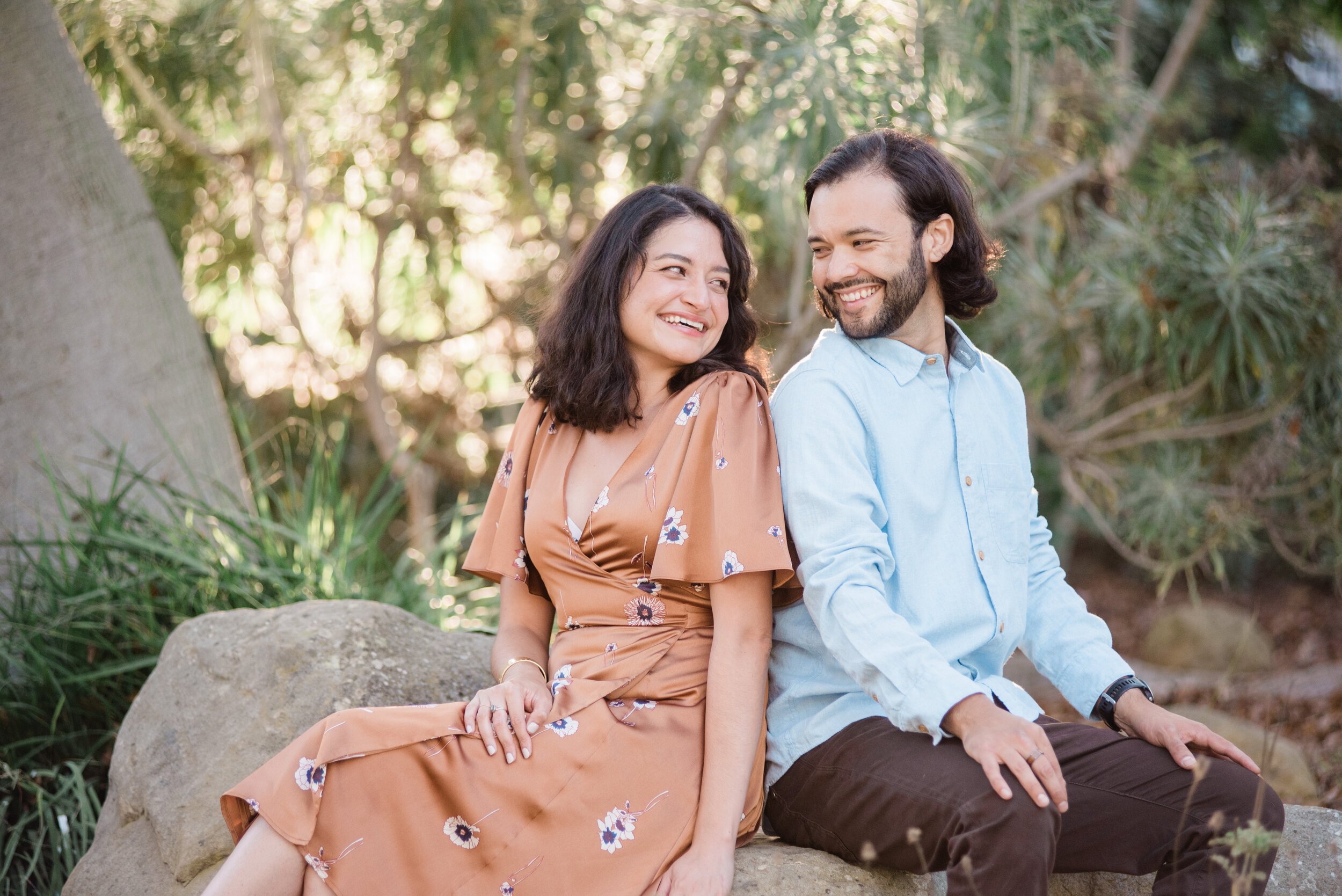 www.santabarbarawedding.com | ByCherry Photography | Alice Keck Park Memorial Garden | Couple Sitting on a Rock Together in the Garden