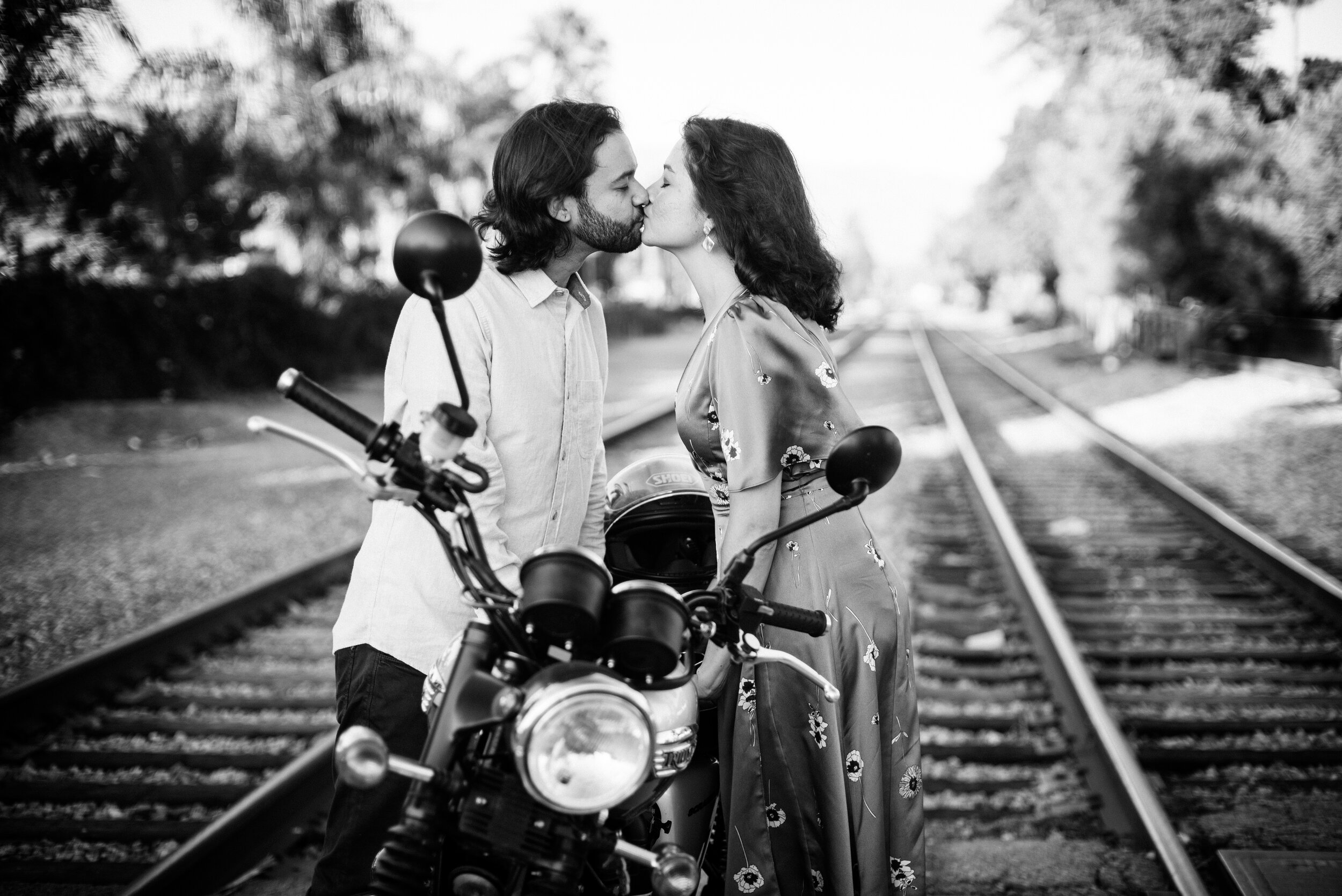 www.santabarbarawedding.com | ByCherry Photography | Funk Zone | Couple Kissing by a Motorcycle on the Railroad Tracks