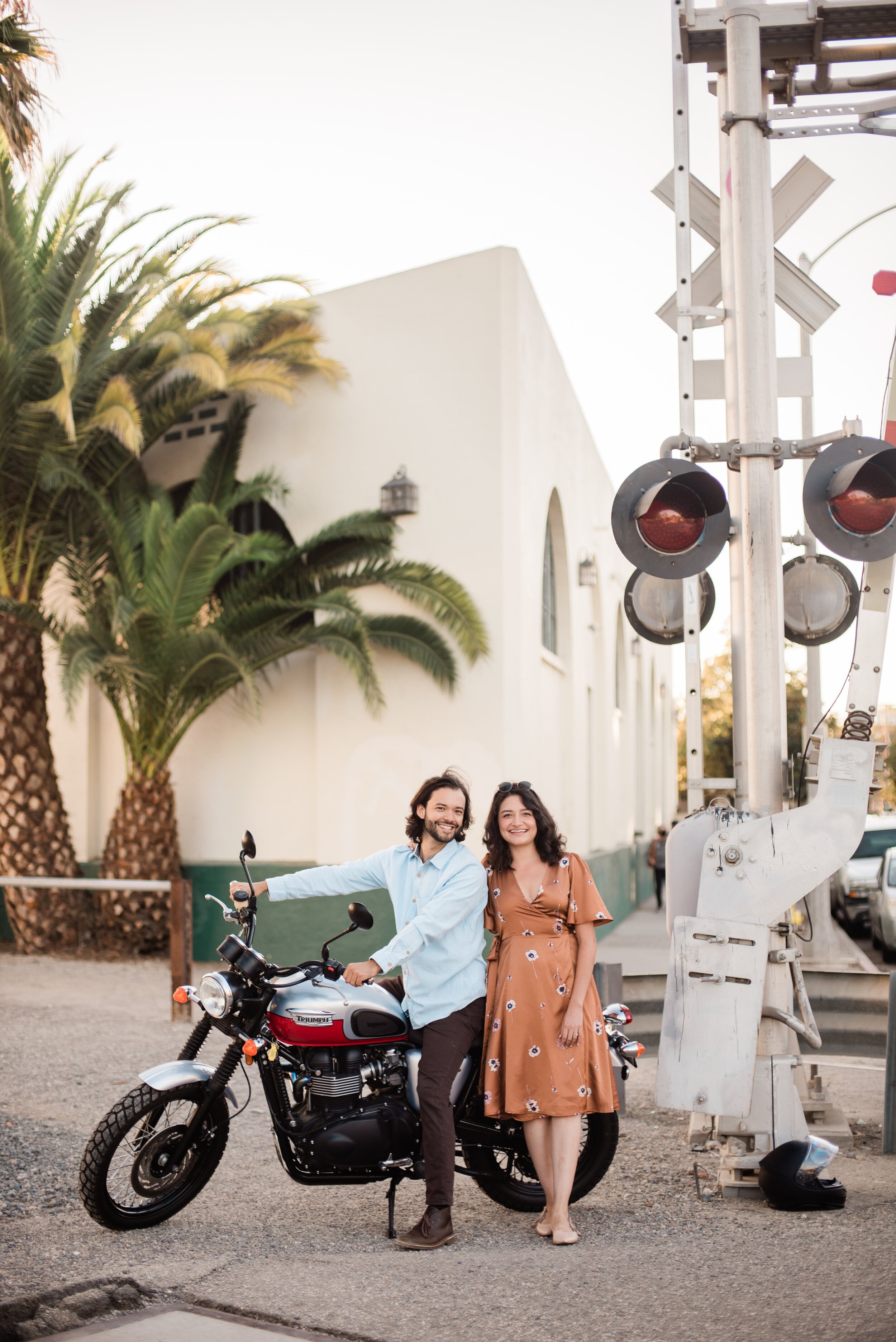 www.santabarbarawedding.com | ByCherry Photography | Funk Zone | Couple Downtown on a Motorcycle by the Railroad Crossing