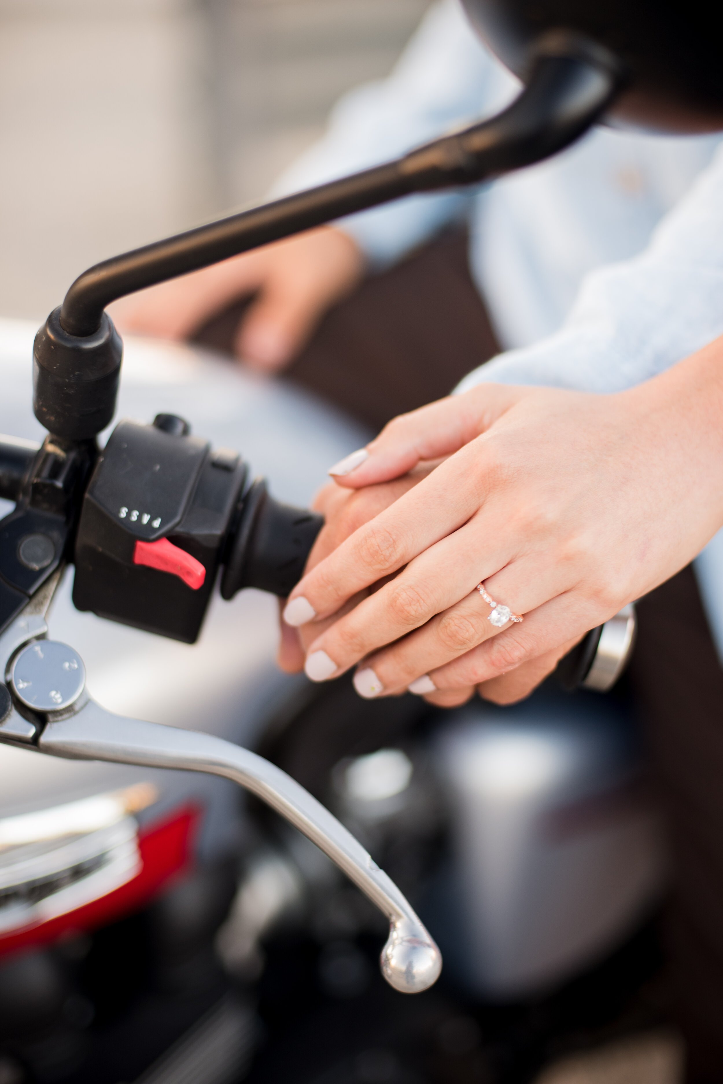 www.santabarbarawedding.com | ByCherry Photography | Funk Zone | Close Up of the Couple’s Hands and Bride-to-Be’s Engagement Ring on the Motorcycle Handlebar