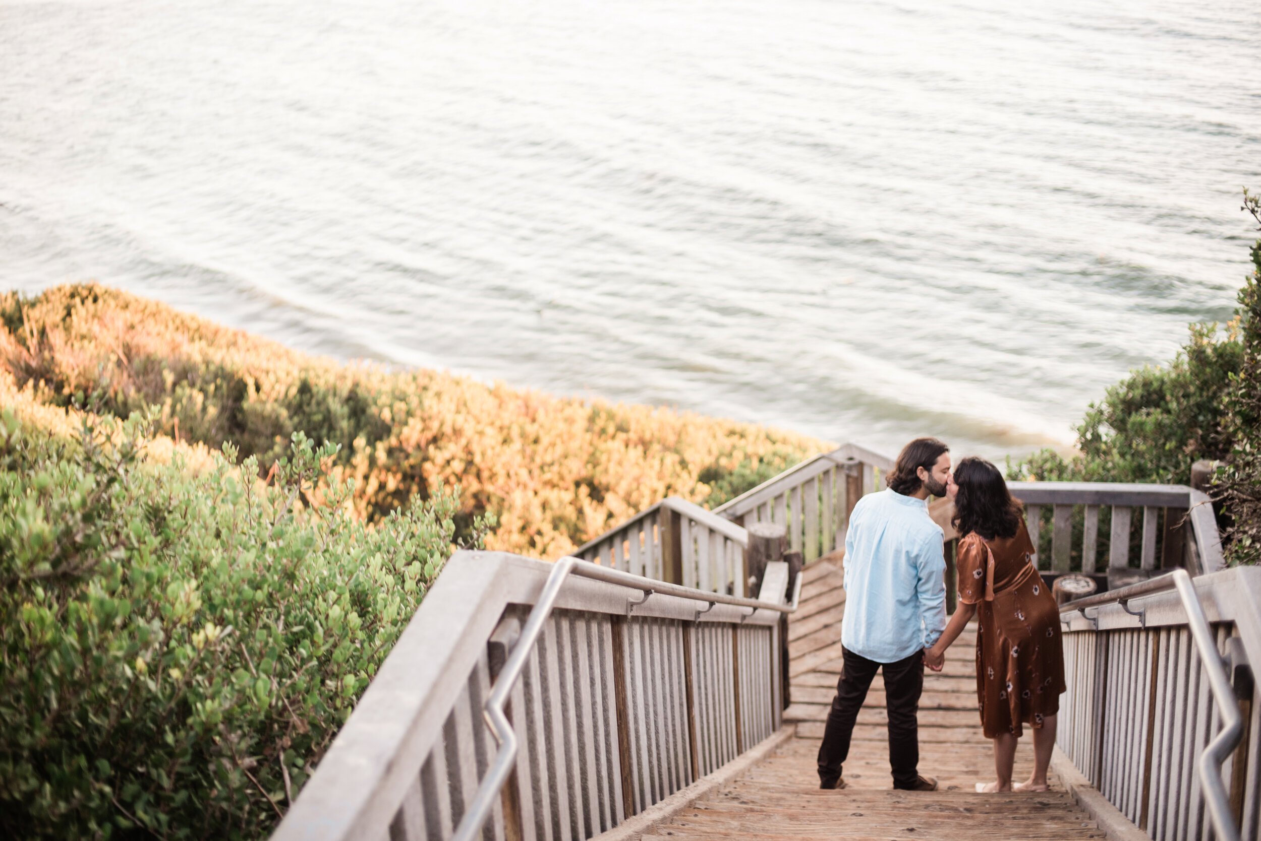 www.santabarbarawedding.com | ByCherry Photography | Mesa Lane Beach | Couple Kissing on the Stairs Down to the Beach