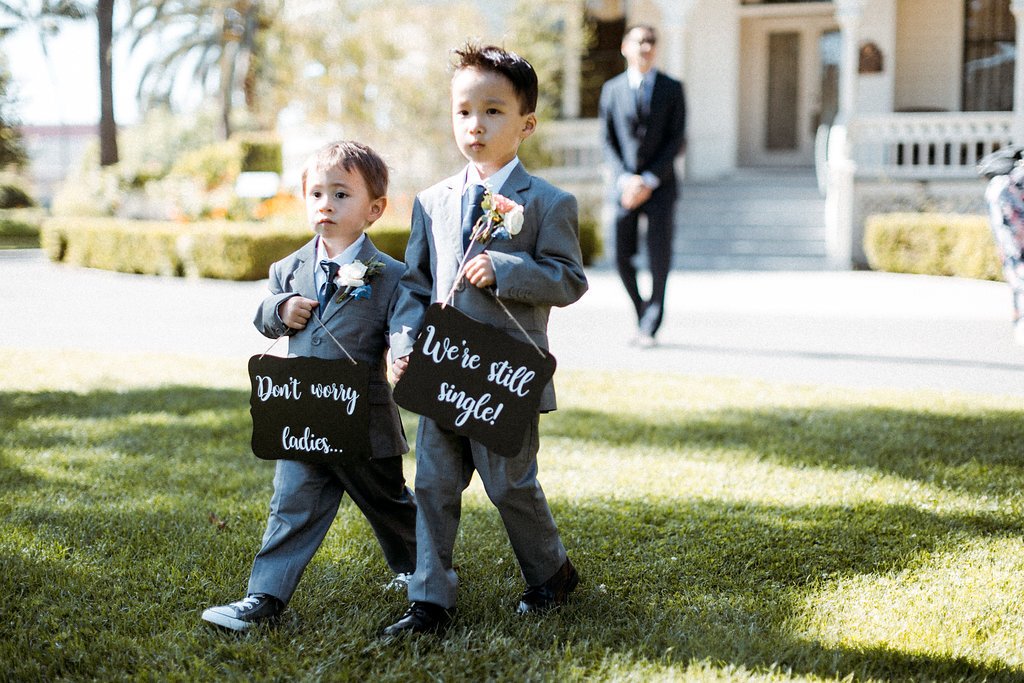 www.santabarbarawedding.com | Abi Q Photography | Camarillo Ranch | White Blossom | Unique Floral Designs | Ring Bearers Walking Into the Ceremony with Signs