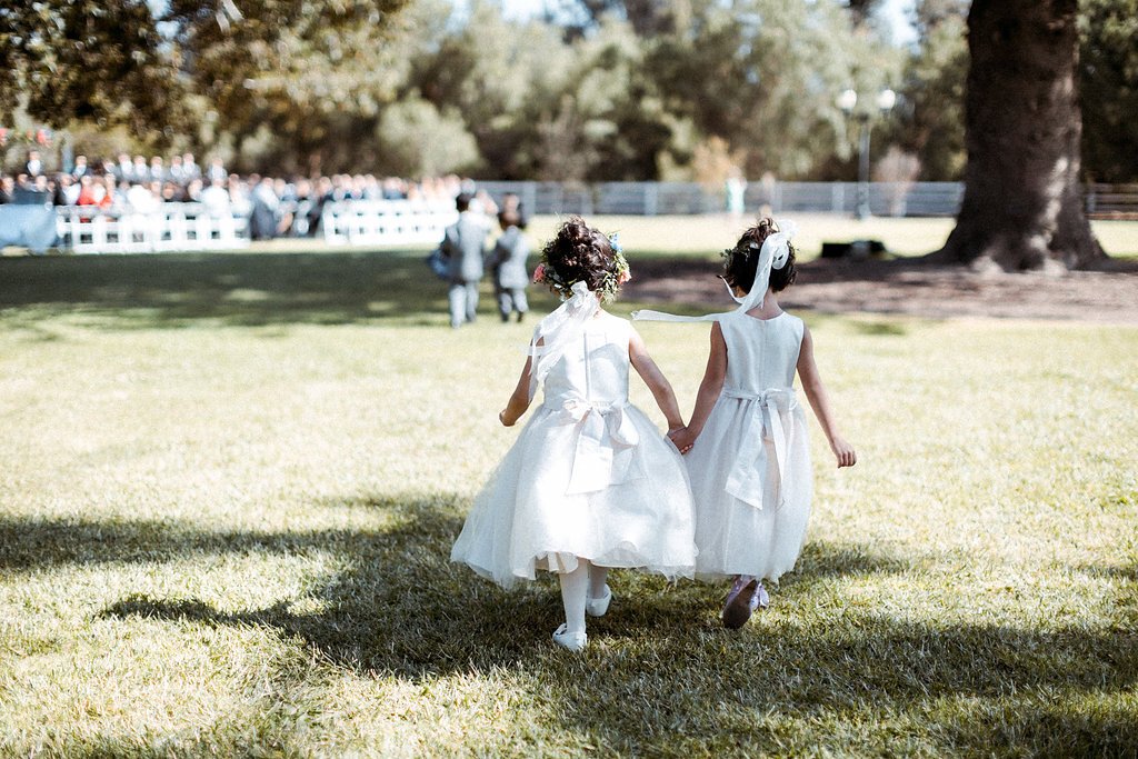 www.santabarbarawedding.com | Abi Q Photography | Camarillo Ranch | White Blossom | Unique Floral Designs | Kelly Zhang | Party Pleasers | Flower Girls Walking Into the Ceremony 
