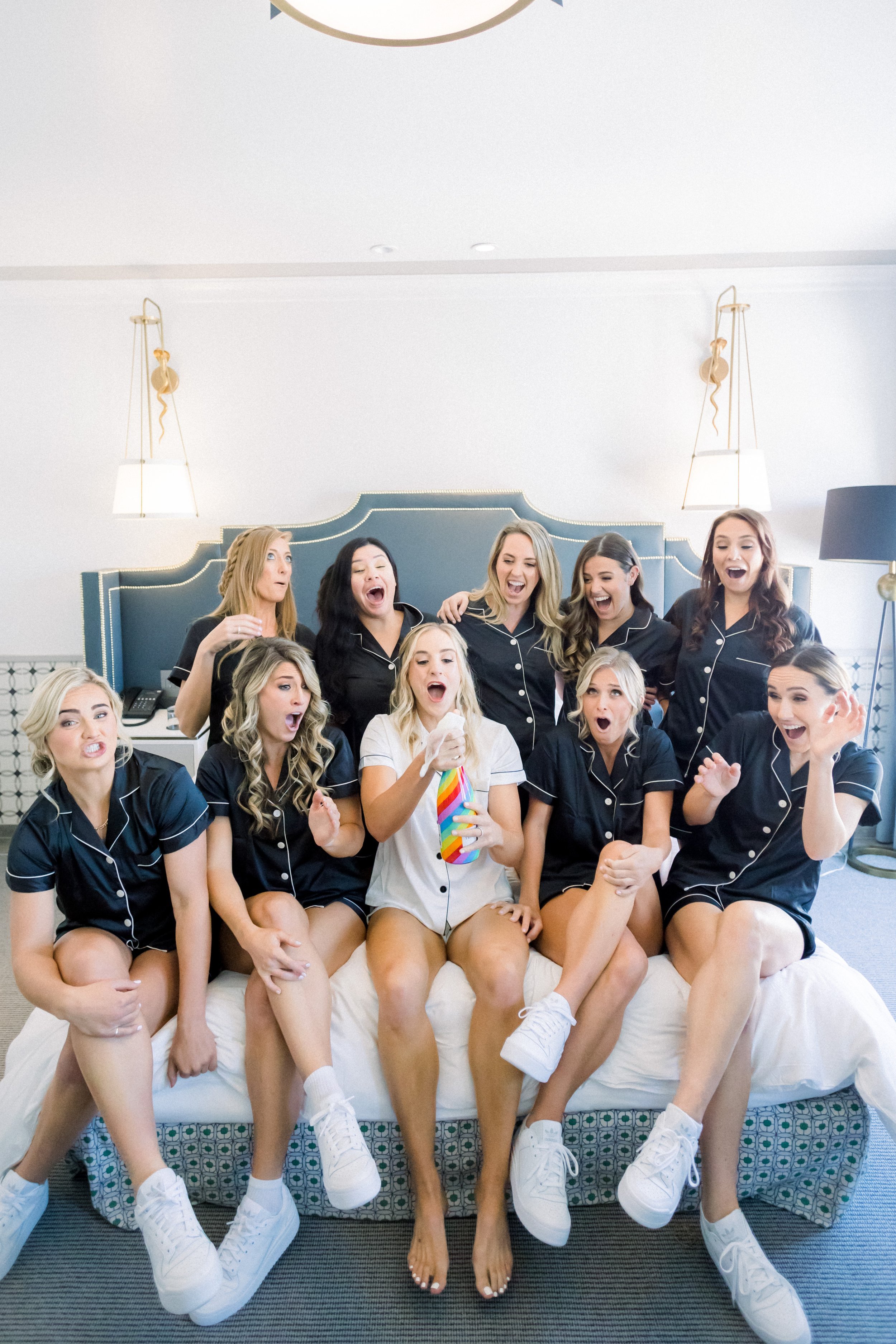 www.santabarbarawedding.com | James &amp; Jess | MOXI | Ann Johnson Events | One Bride Surrounded by Bridesmaids in Matching Pajamas Drinking Champagne