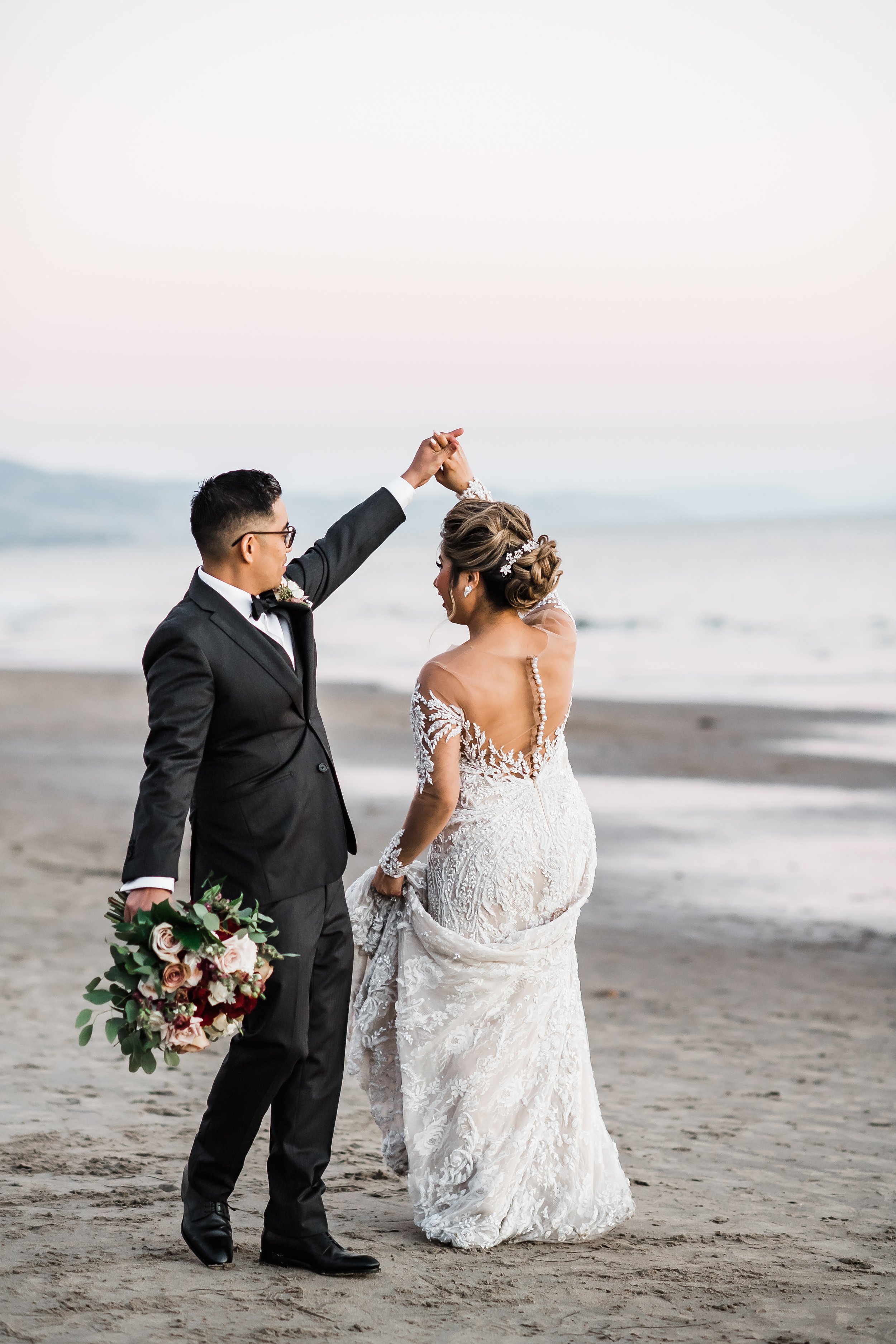 www.santabarbarawedding.com | Rosewood Miramar | Events by Maxi | Michelle Ramirez | Tangled Lotus | Bride and Groom Twirling on the Beach