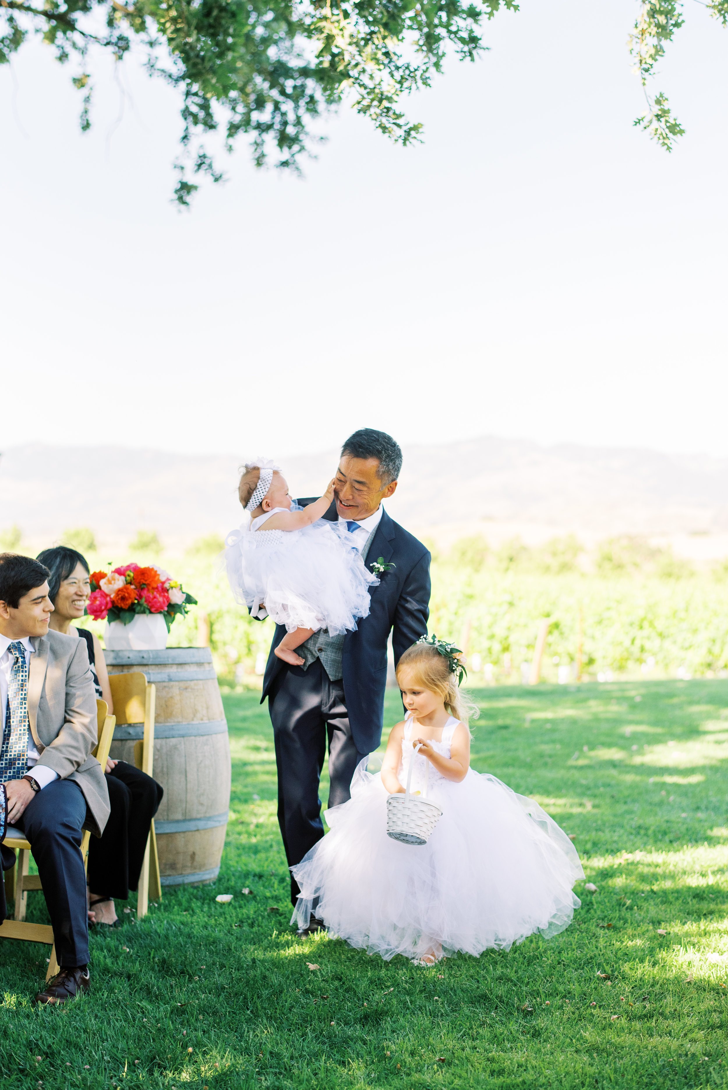 www.santabarbarawedding.com | Loveridge Photography | Gainey Vineyard | Amber Alyse Events | Besame Floral | Bright Event Rentals | Father of Groom Leads Flower Girls Down the Aisle