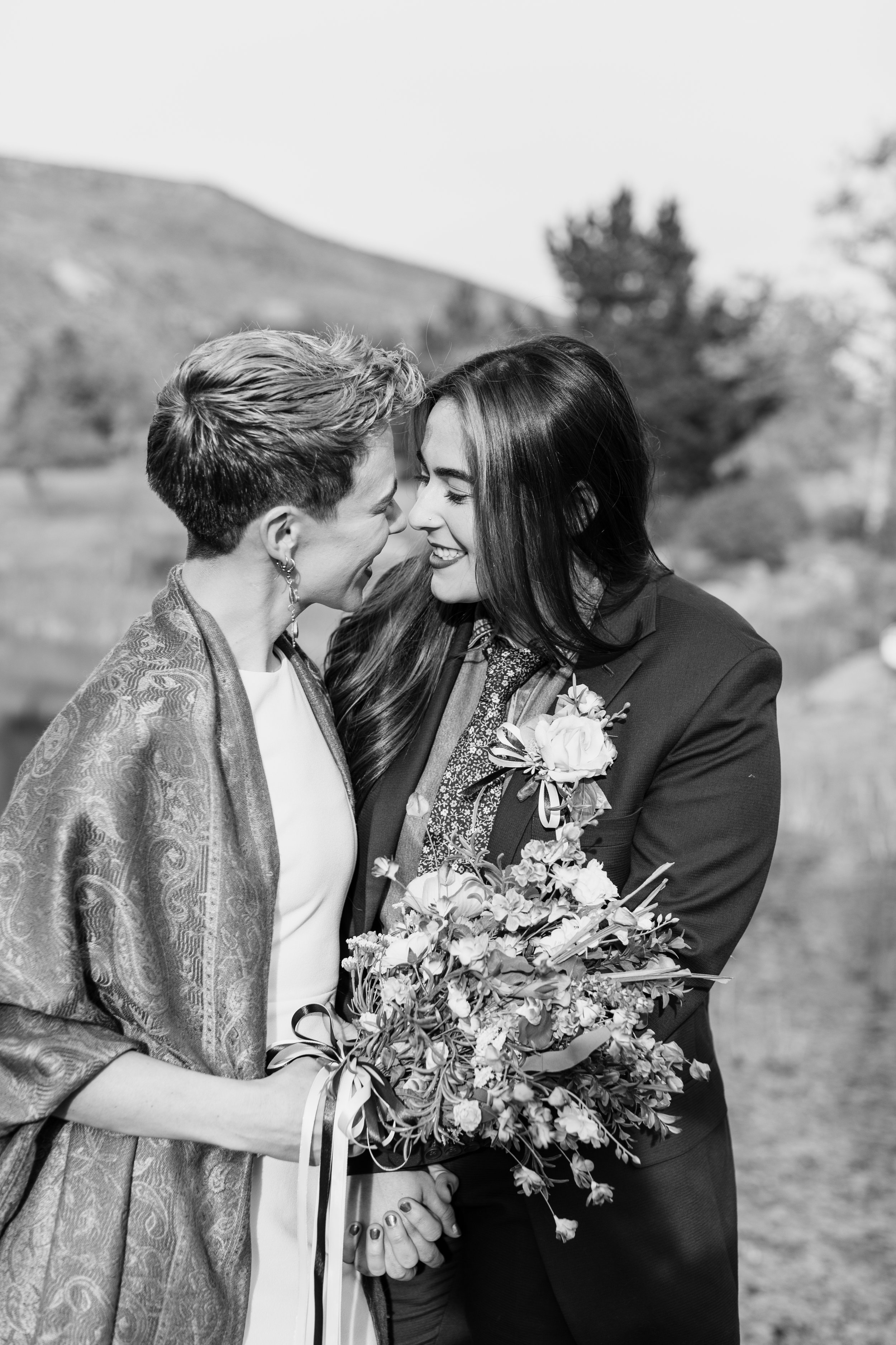 www.santabarbarawedding.com | MacKenzie Rana Photography | Fish House San Luis Obispo | Couple Embracing with Bouquet at Engagement Shoot