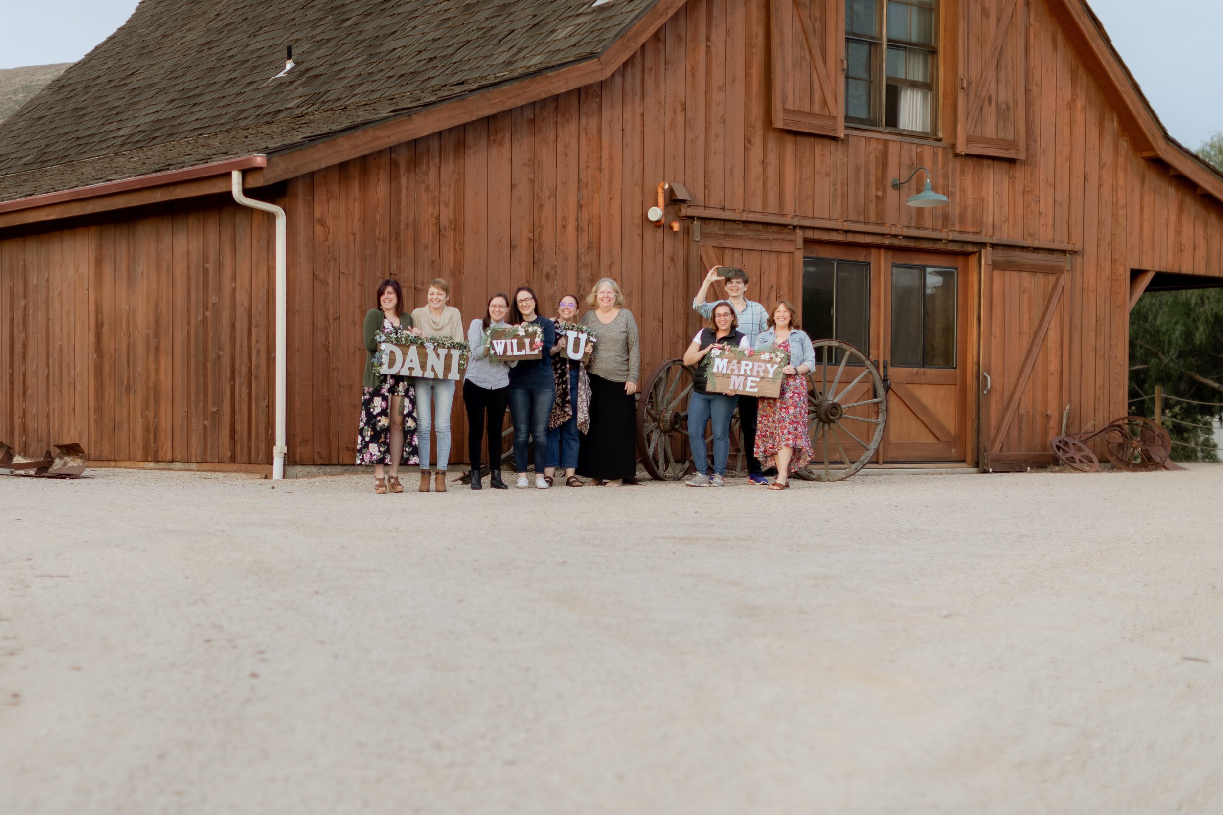 www.santabarbarawedding.com | MacKenzie Rana Photography | Fish House San Luis Obispo | Friends and Family Holding Signs at  Engagement Shoot