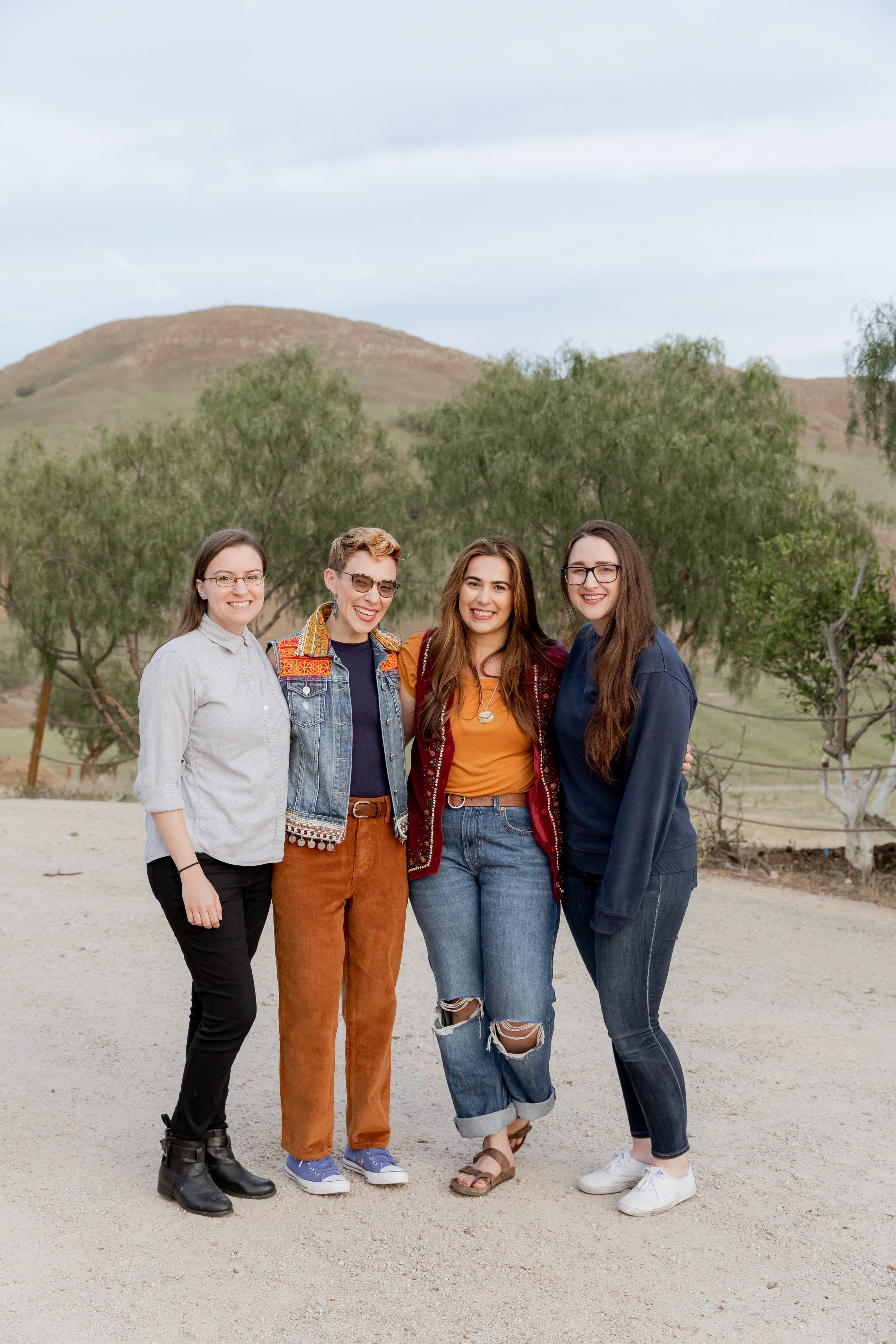 www.santabarbarawedding.com | MacKenzie Rana Photography | Fish House San Luis Obispo | Couple Posing with Friends and Family at Engagement Shoot