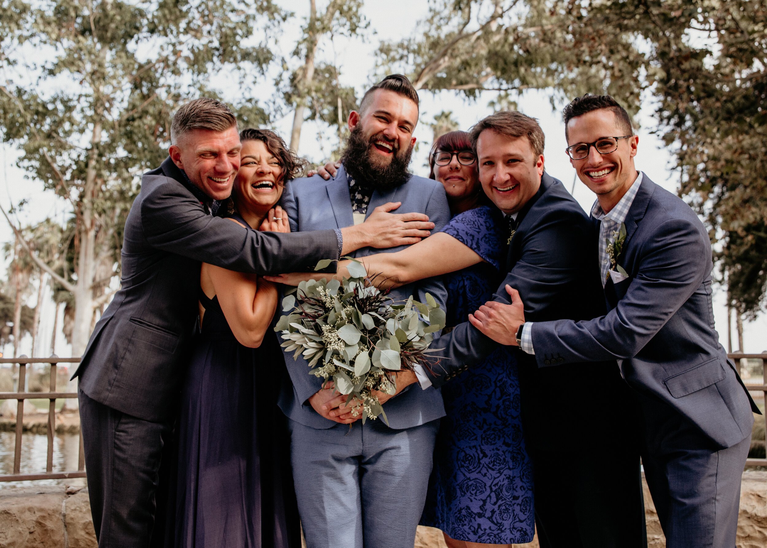 www.santabarbarawedding.com | Carousel House | AE Photography | Rancho Santa Cecilia | Groom with Bouquet Surrounded by Friends