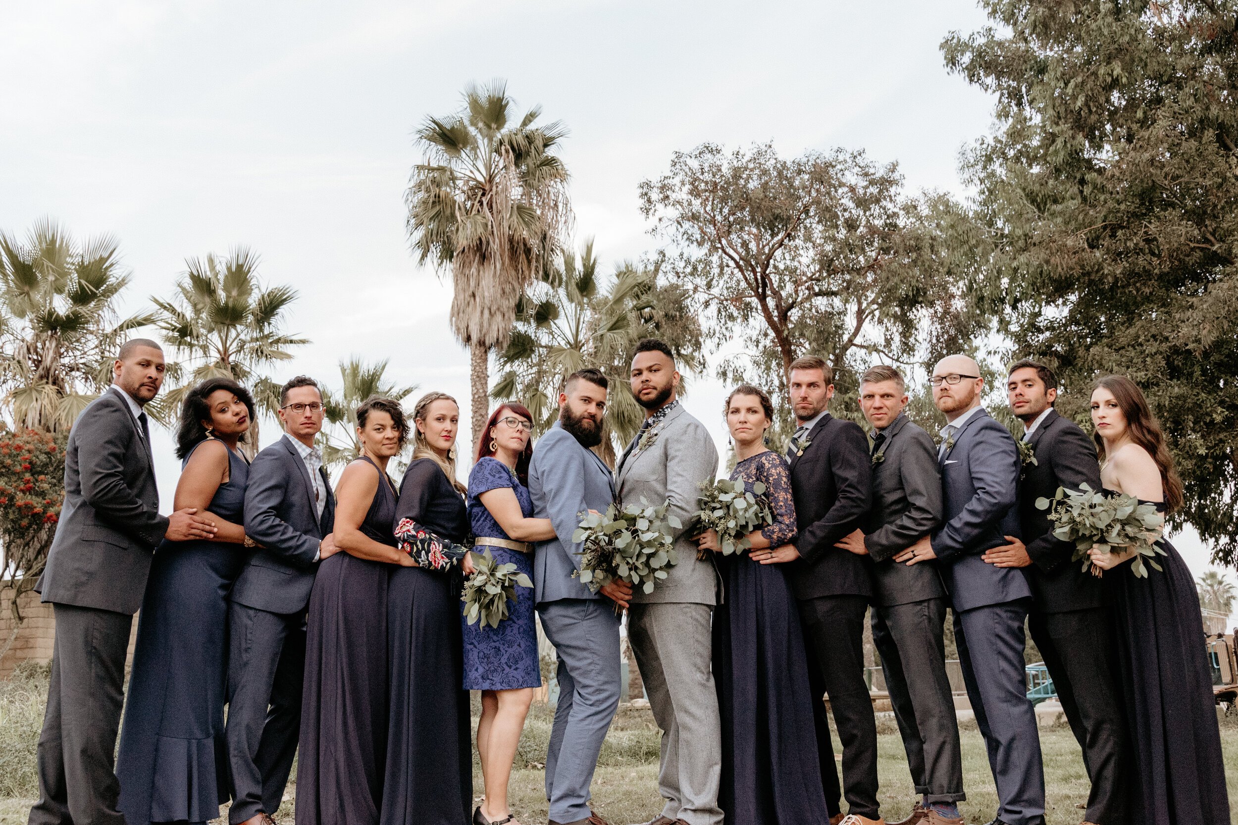 www.santabarbarawedding.com | Carousel House | AE Photography | Rancho Santa Cecilia | Both Grooms Surrounded by Wedding Party