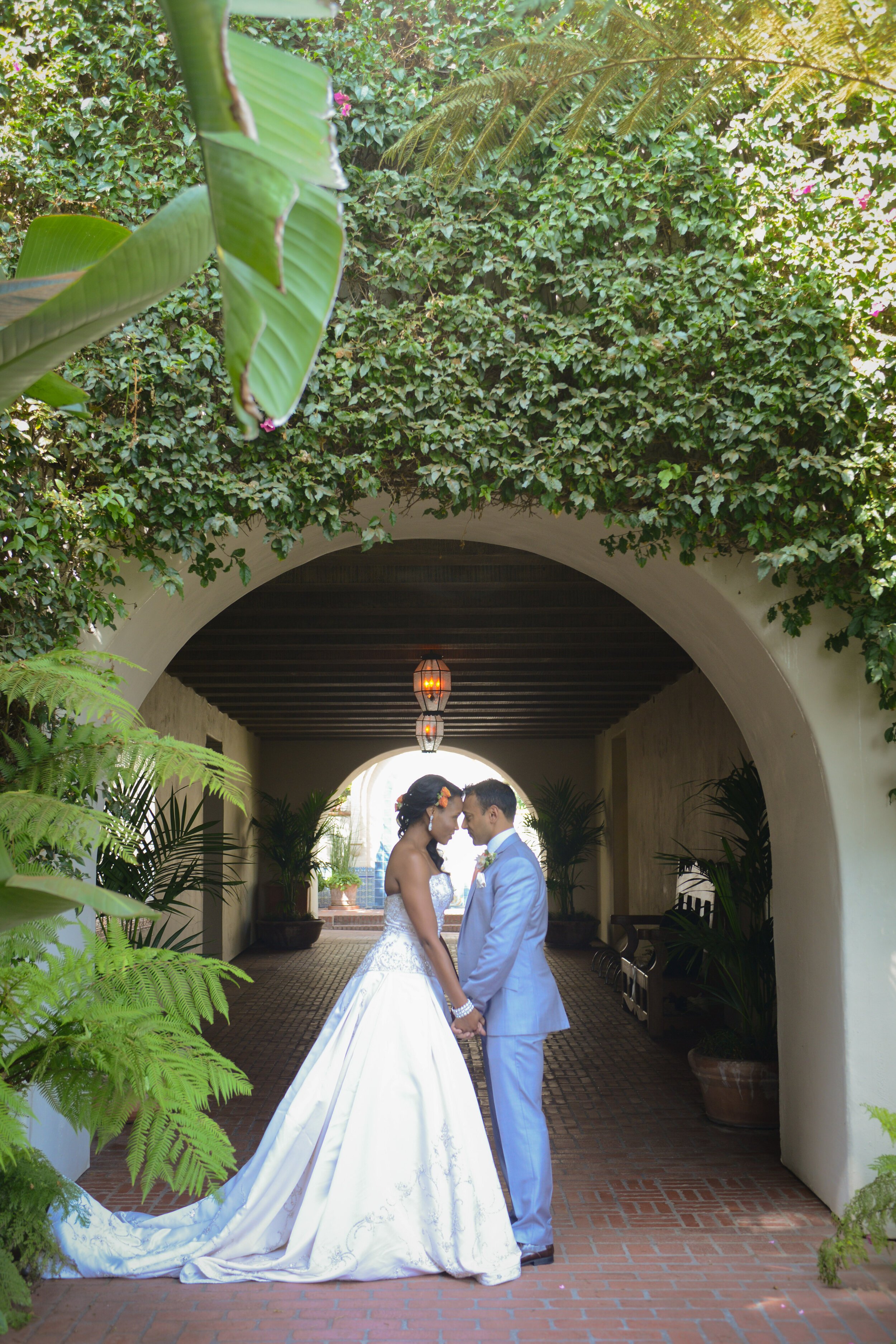 www.santabarbarawedding.com | ByCherry Photography | Dalina Klan | Four Seasons Resort The Biltmore | Cheryl Nacario | Bride and Groom Share a Moment Under Beautiful Arch