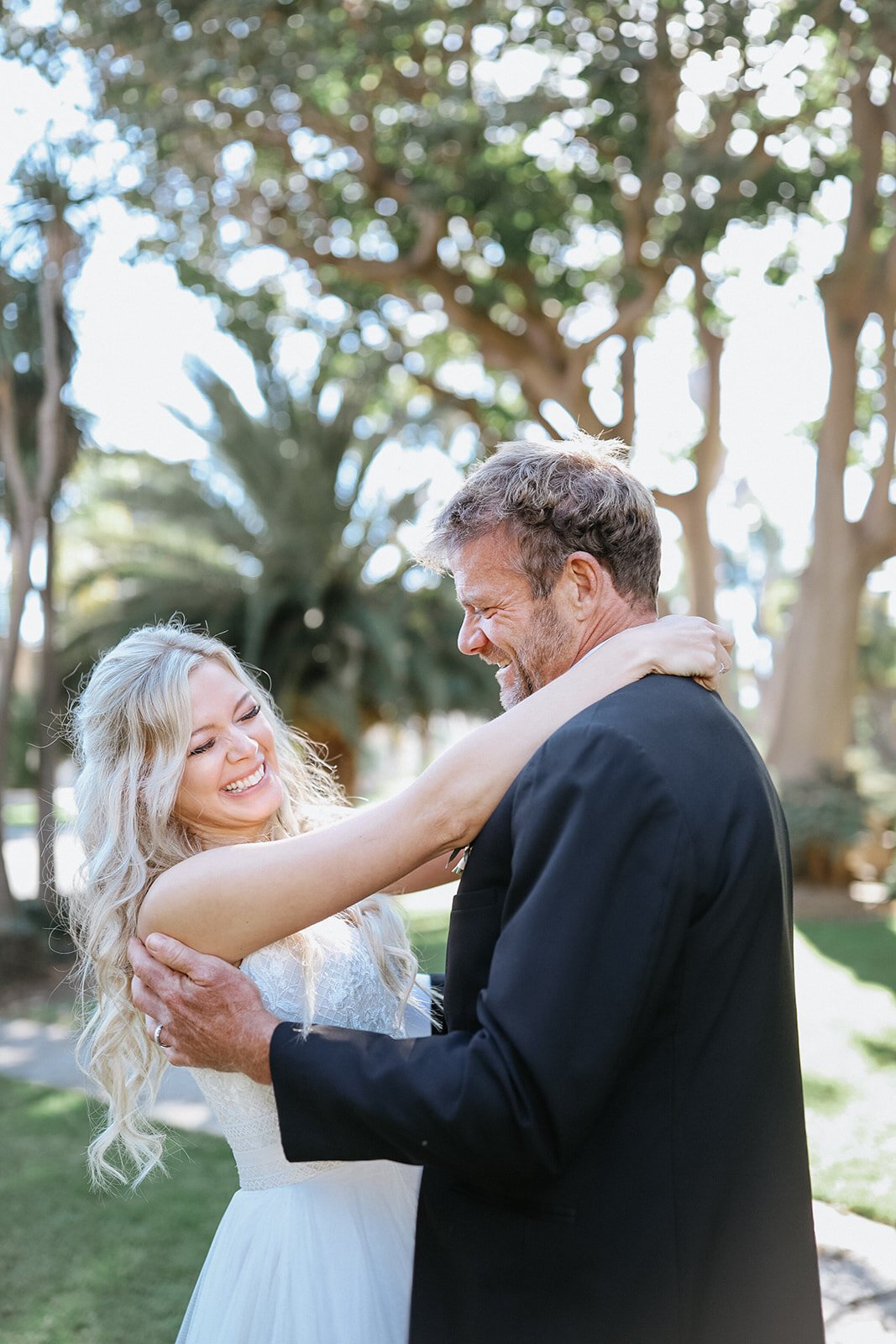 www.santabarbarawedding.com | Santa Barbara Courthouse | Blink Aesthetics | Santa Barbara Classic Weddings | The Dress Bride | Alexis Ireland Florals | Couple Embrace After Ceremony
