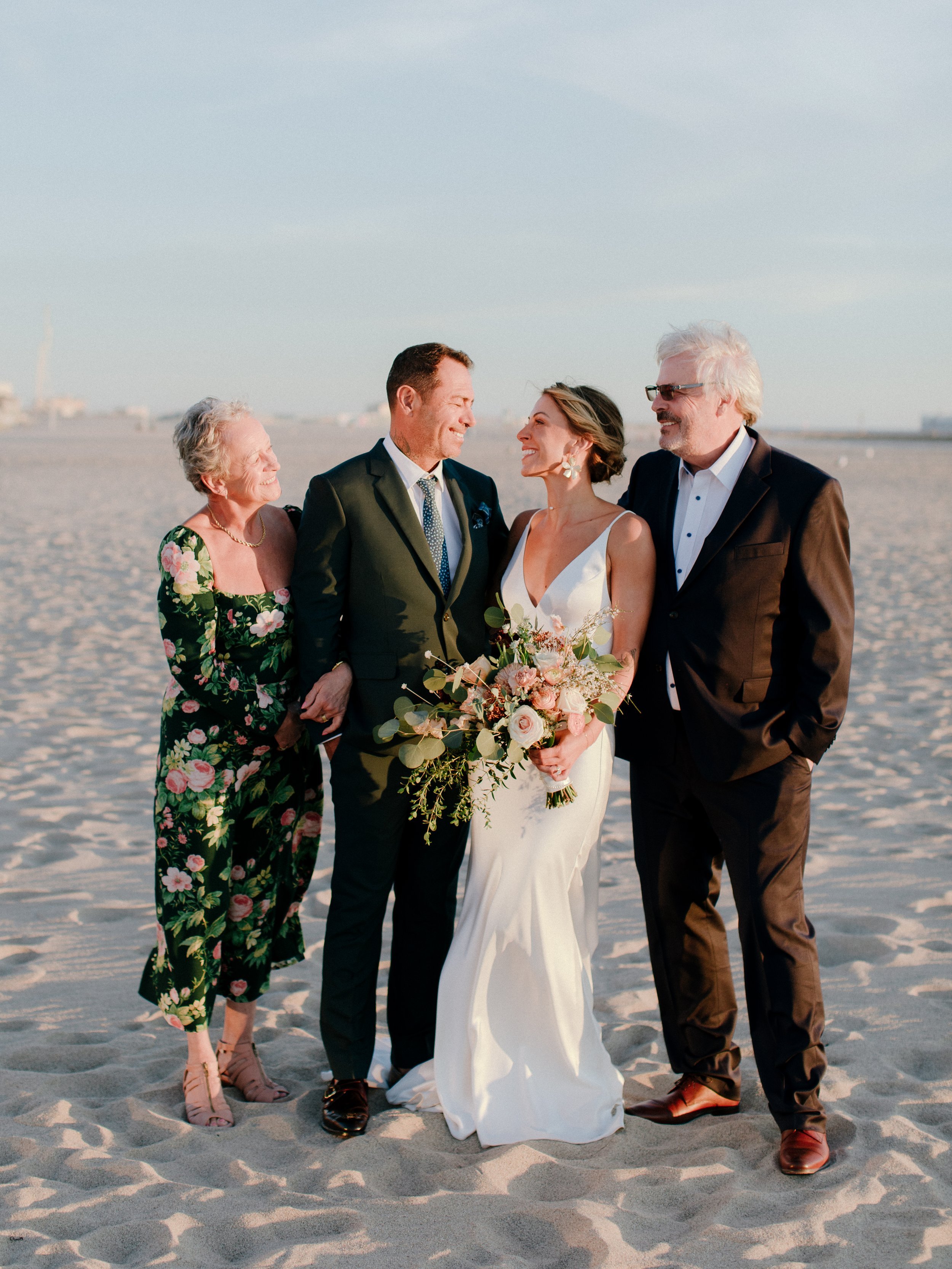 www.santabarbarawedding.com | Chris J. Evans | Paul Smith Suit | Couple with The Brides Parents on the Beach
