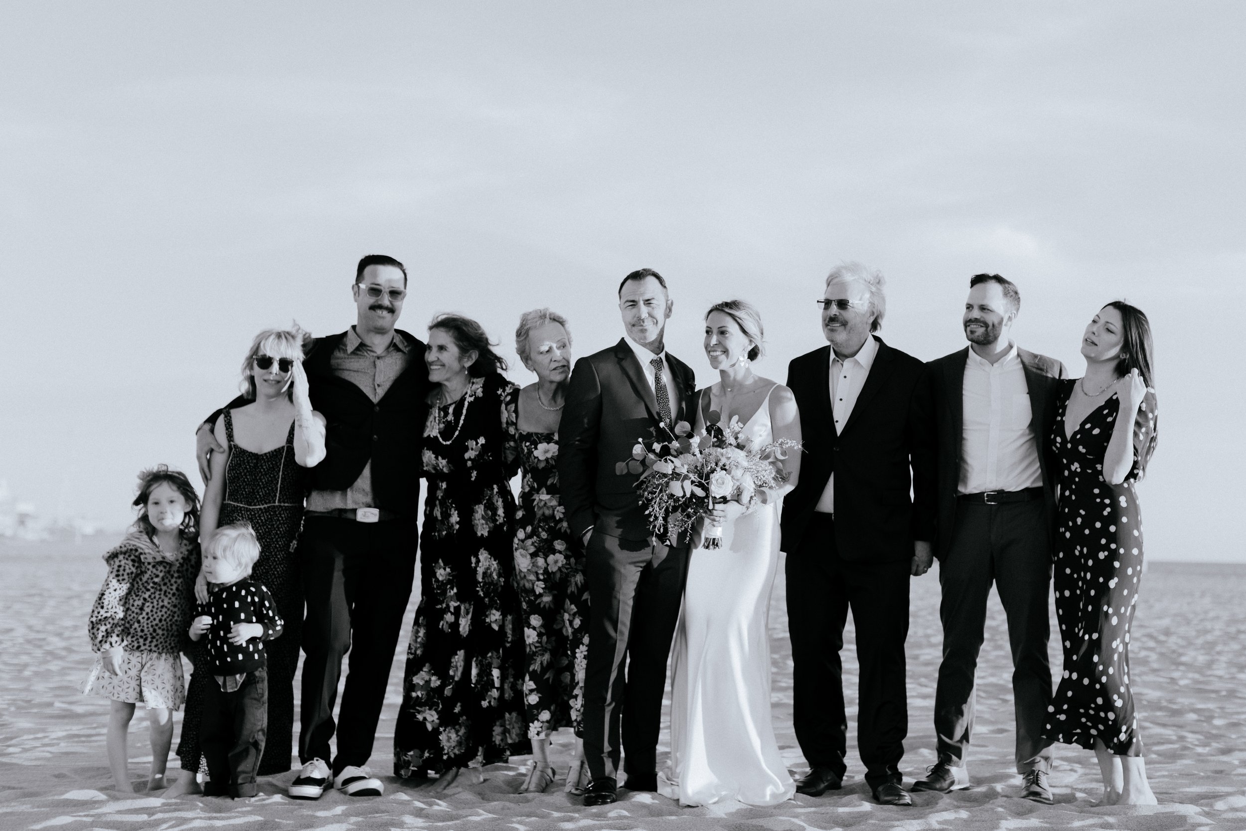 www.santabarbarawedding.com | Chris J. Evans | Paul Smith Suit | Couple with Their Families on the Beach