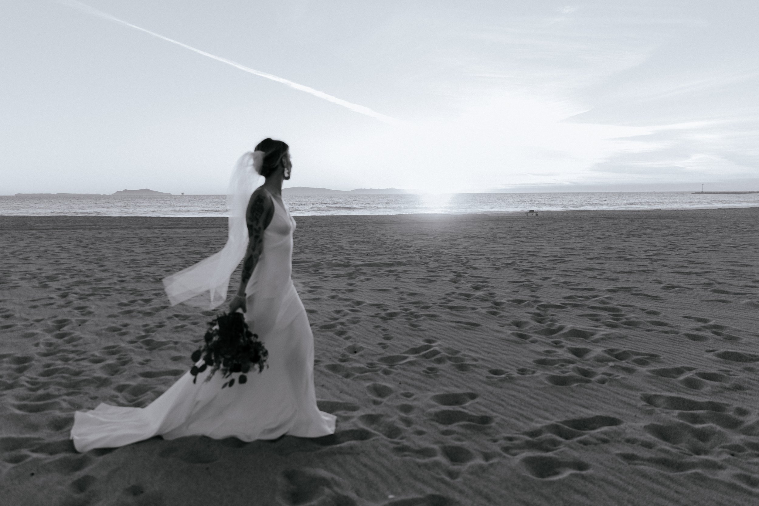 www.santabarbarawedding.com | Chris J. Evans | Paul Smith Suit | Bride Walking with Bouquet on the Beach 