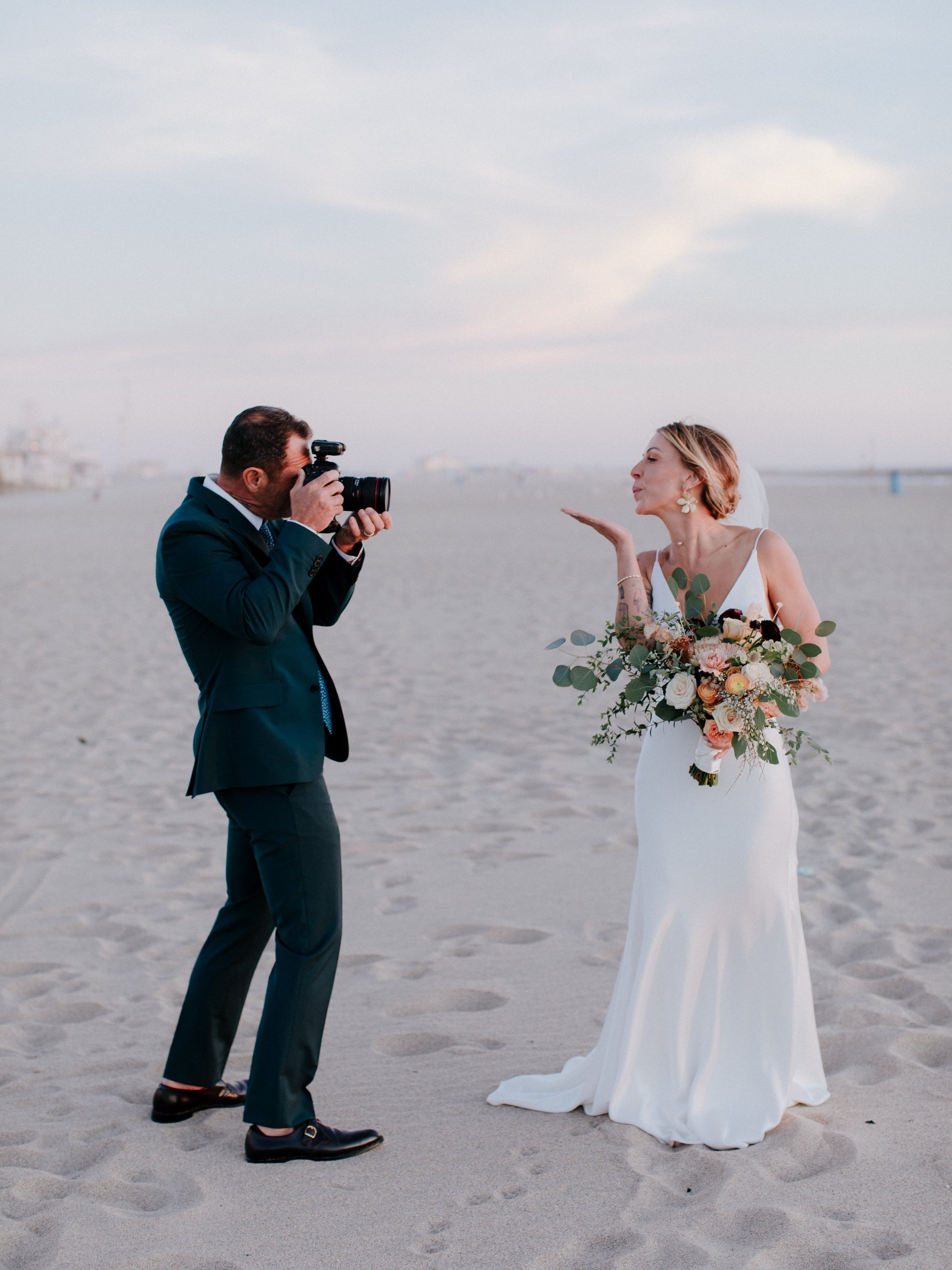 www.santabarbarawedding.com | Chris J. Evans | Paul Smith Suit | Groom Taking a Picture of the Bride on the Beach