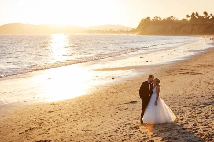 www.santabarbarawedding.com | Butterfly Beach | Christian Oth Studio | Couple Kissing on the Beach at Sunset