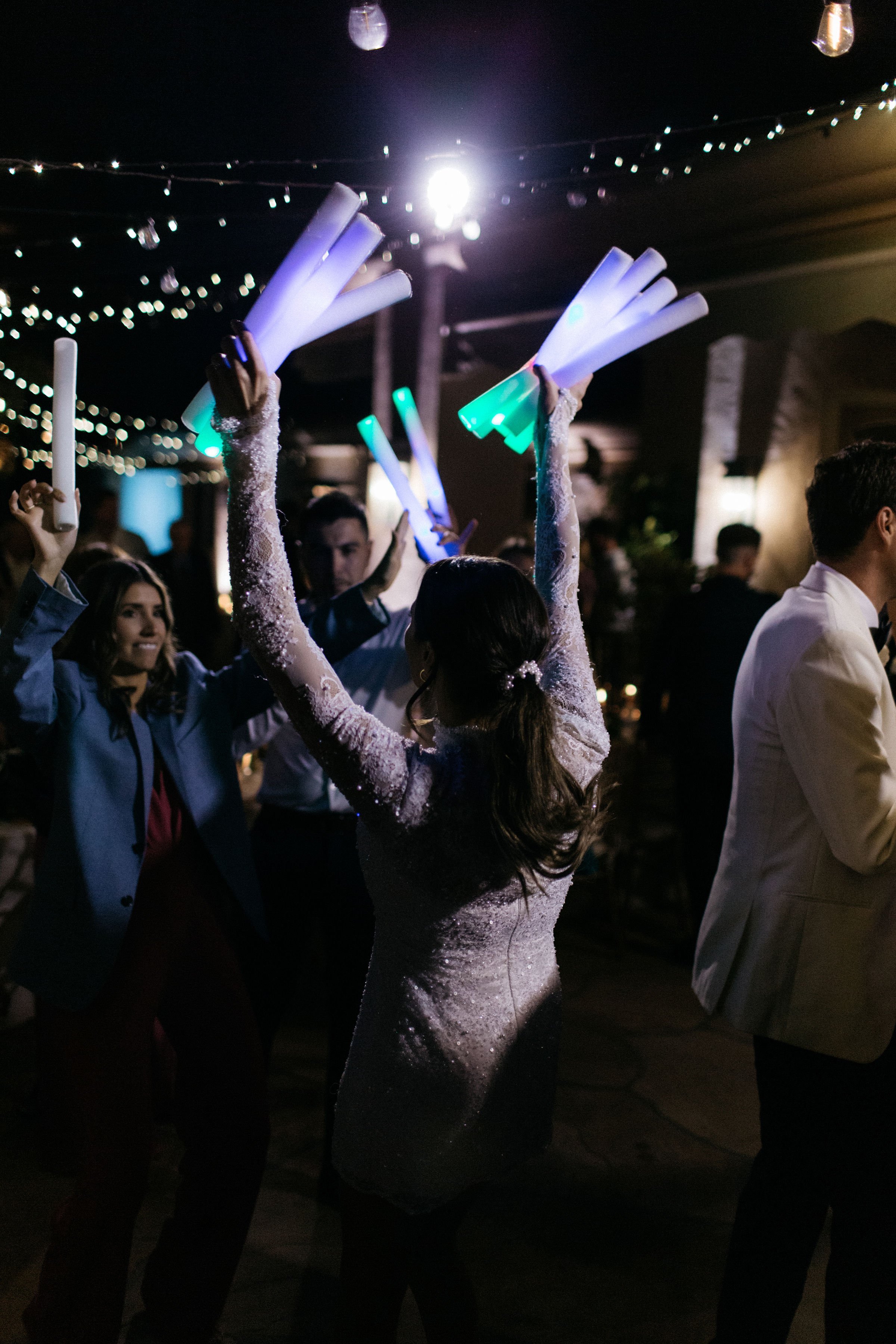 www.santabarbarawedding.com | Villa Verano | Alexander Thomas | Amie Brie Events | Islay Events |  Team Hair &amp; Makeup | Bride Handing Out Light Up Batons at Reception 