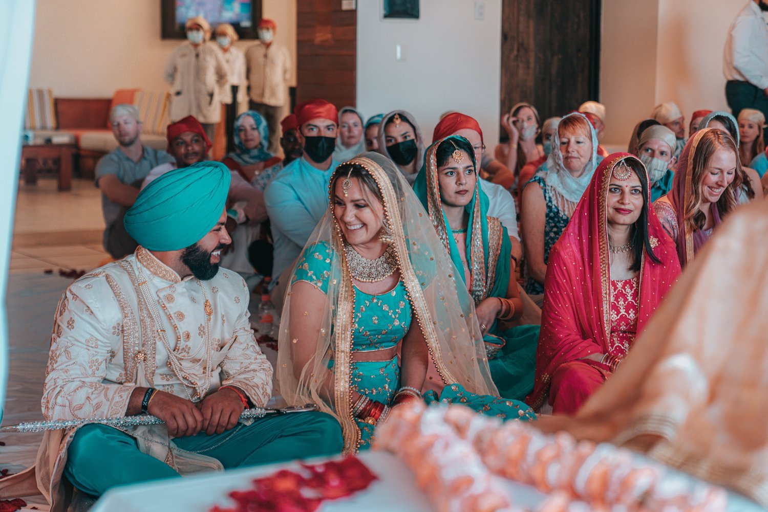 www.santabarbarawedding.com | Golden Glow Weddings | Hyatt Ziva Los Cabos | Diego Chavez | Addison Parrish | Bride and Groom Sitting at Traditional Indian Ceremony 
