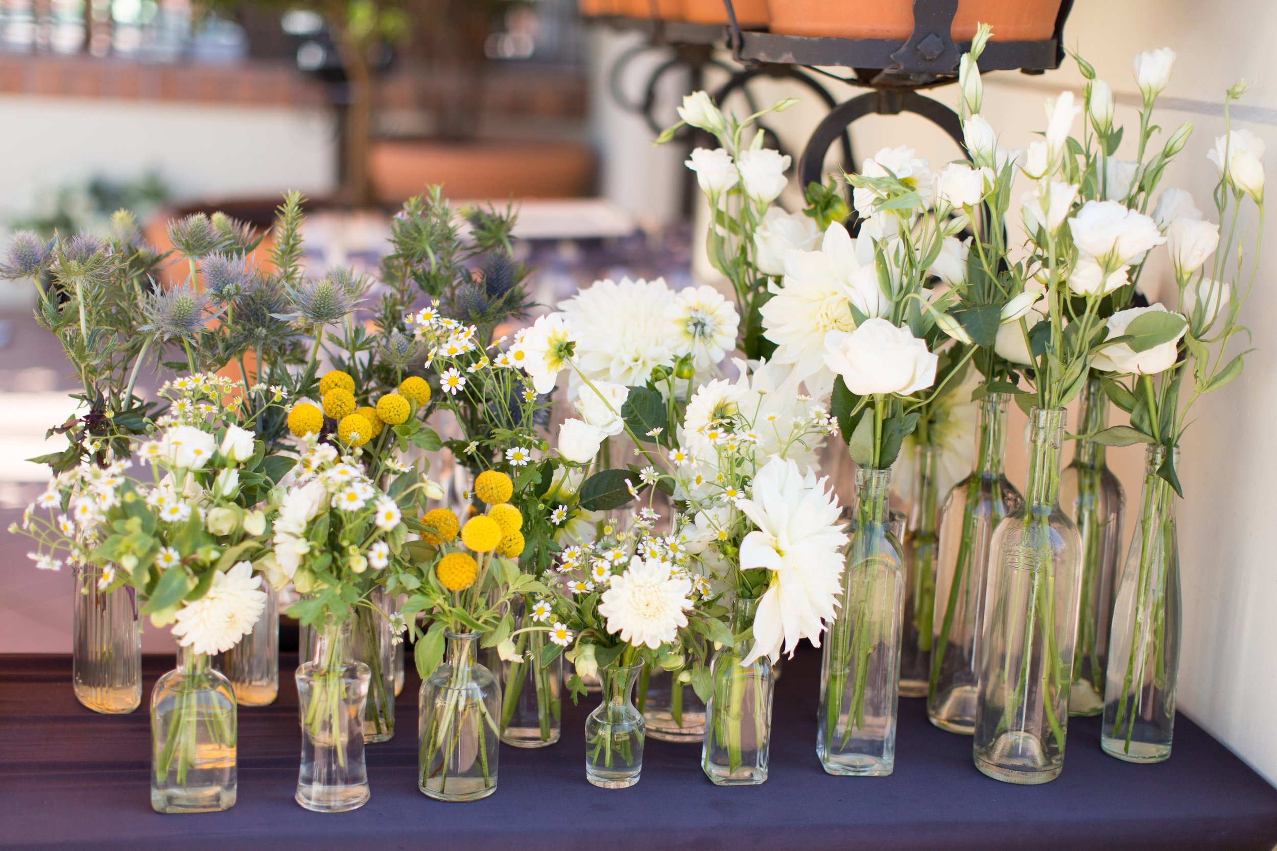 www.santabarbarawedding.com | Margaret Joan Florals | Wonder Tribe Photography | White and Yellow Flowers in Clear Vases