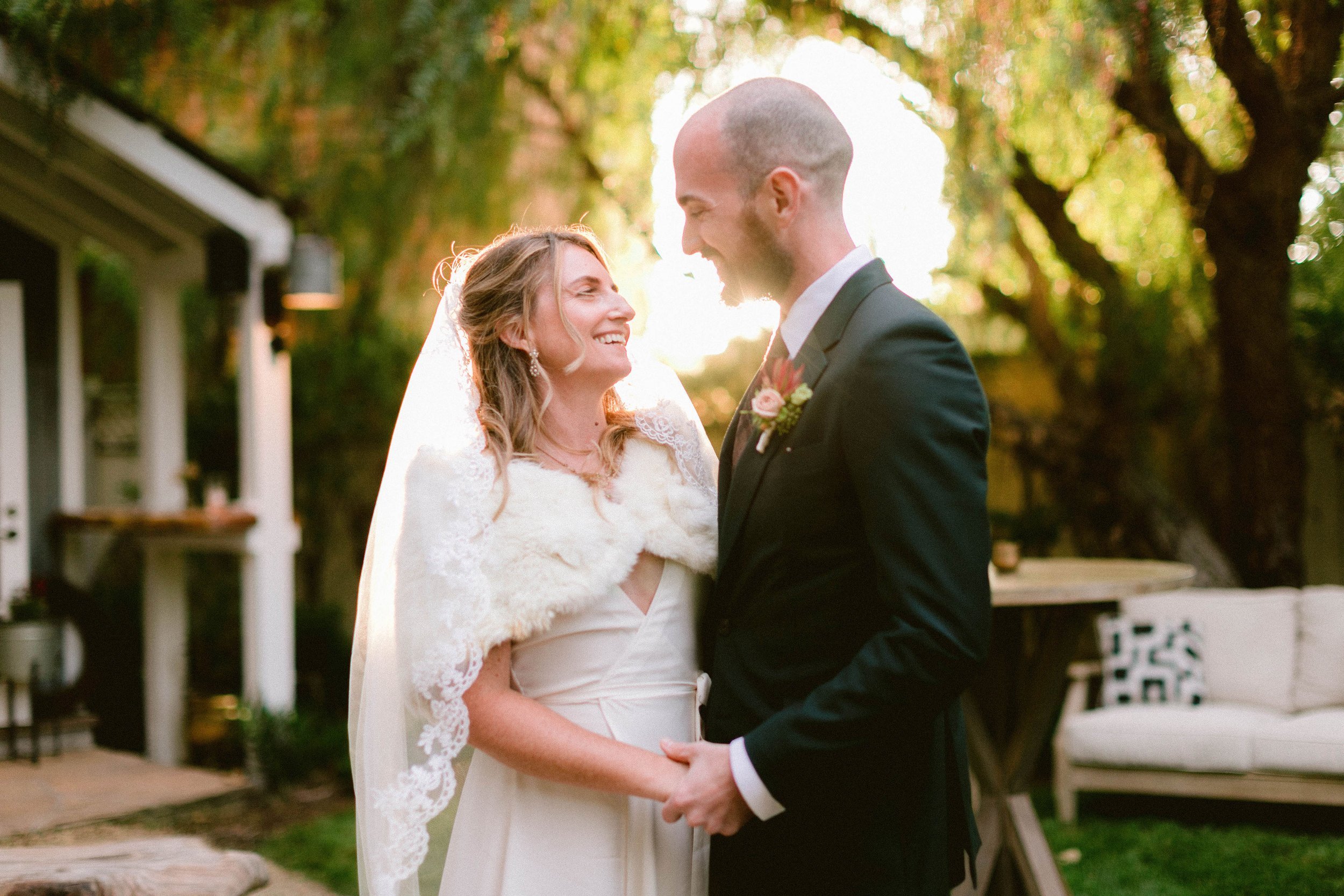 www.santabarbarawedding.com | Brittany Taylor Photography | Swell Studio Events | The Maker’s Son | Alpha Floral | Carlyle Salon | Bride and Groom Embrace with Sun Shining Behind Them