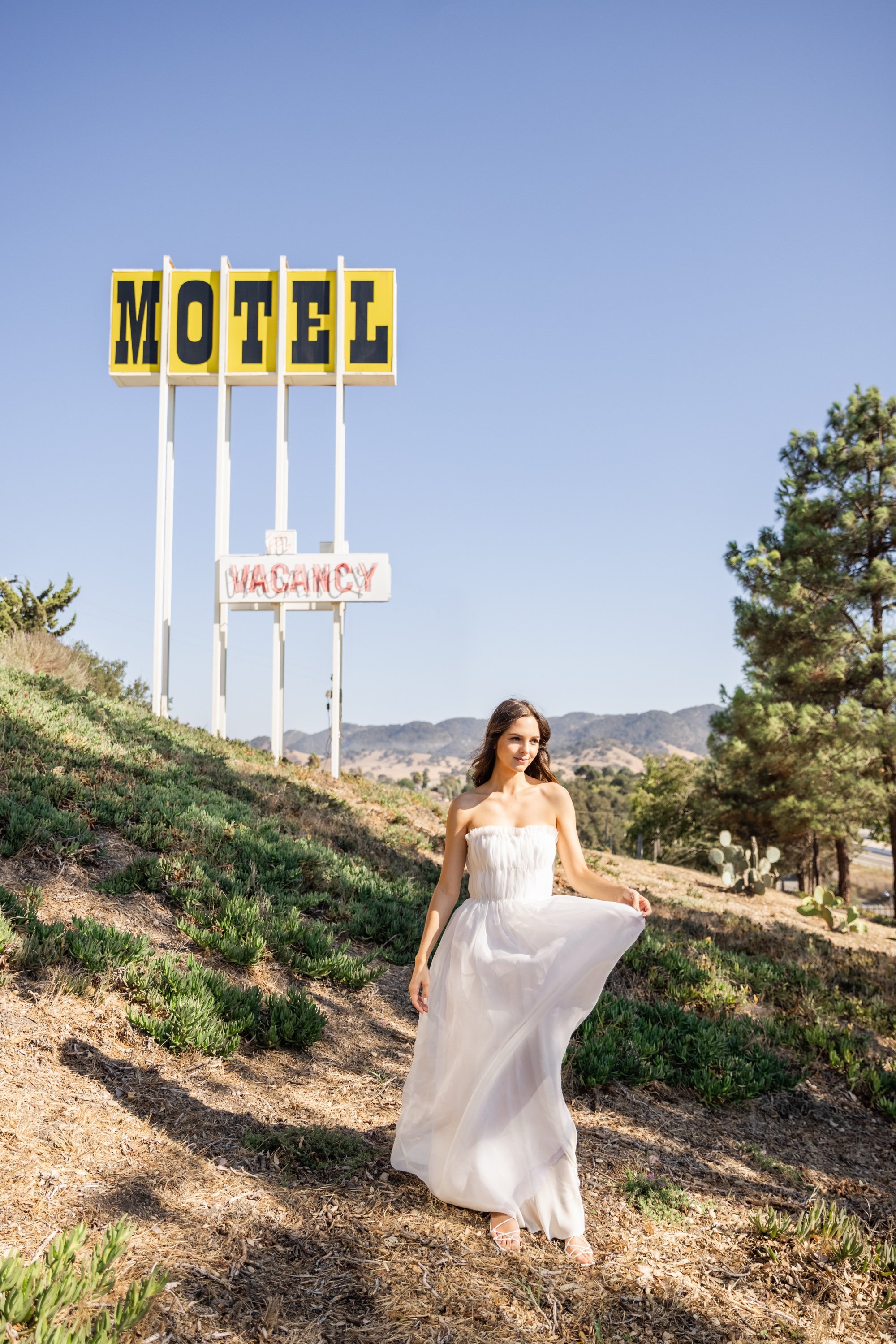 www.santabarbarawedding.com | Santa Ynez Private Residence | Veils &amp; Tails Photography | Bride In Front of the Motel Sign