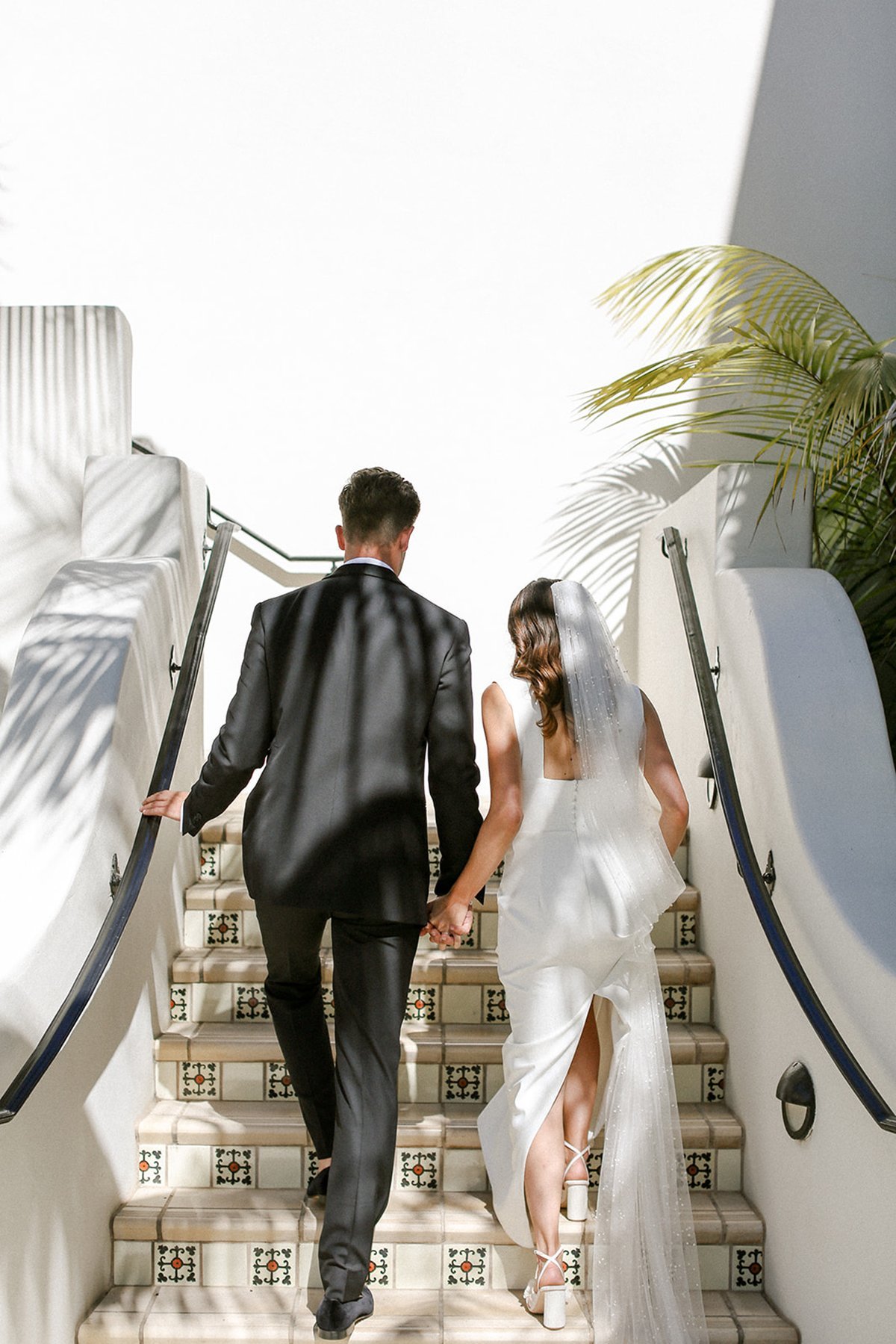 www.santabarbarawedding.com | Ali Beck Photography | LuckEleven Events | The Ritz-Carlton Bacara | Ralph Lauren | Pretty Please Beauty | Sarah Seven | Bride and Groom Going Up the Stairs