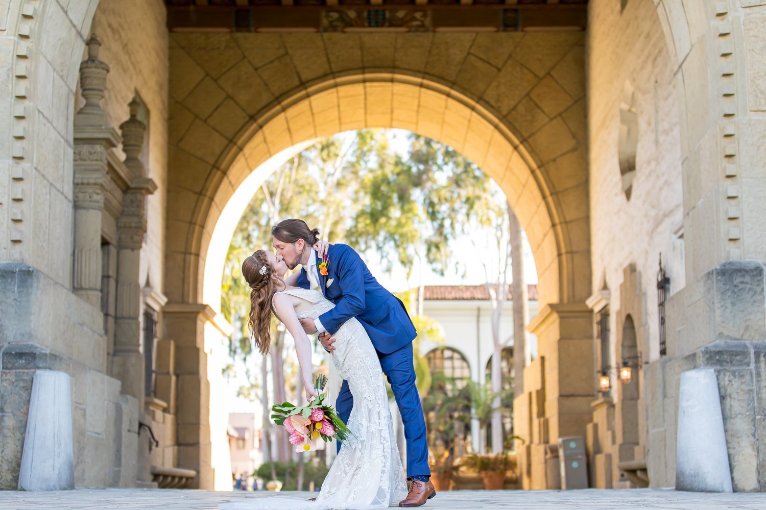 www.santabarbarawedding.com | Santa Barbara Courthouse | Elizabeth Victoria Photography | Hogue &amp; Co. | Floravere | La Rouge Artistry | Bride and Groom Kiss in Front of the Courthouse