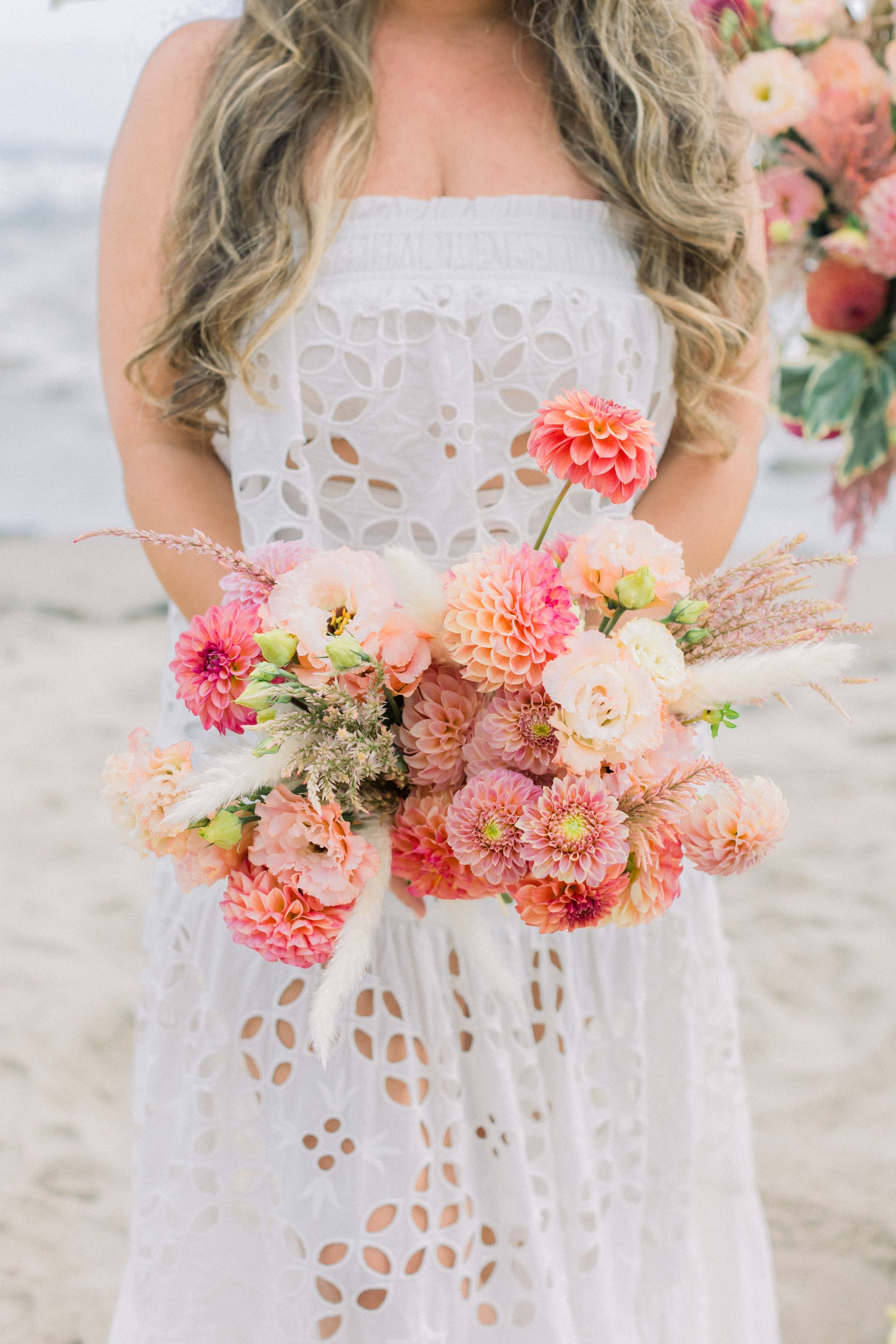 www.santabarbarawedding.com | James &amp; Jess Photography | Slate Catering | All Heart Rentals | Ella &amp; Louie | Free People | Bride Holding Bridal Bouquet on the Beach
