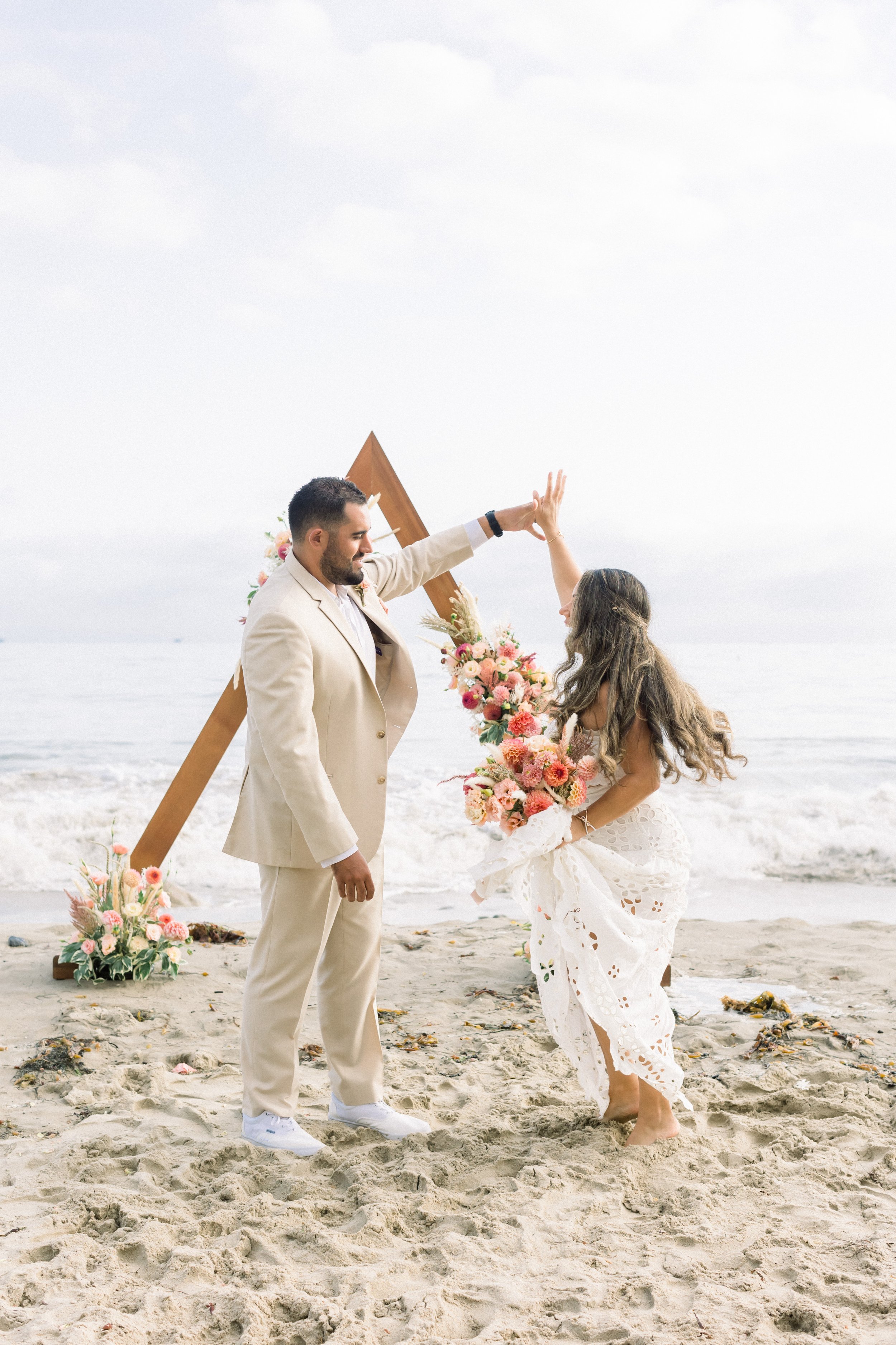 www.santabarbarawedding.com | James &amp; Jess Photography | Slate Catering | All Heart Rentals | Ella &amp; Louie | Free People | Bride and Groom Twirling on the Beach