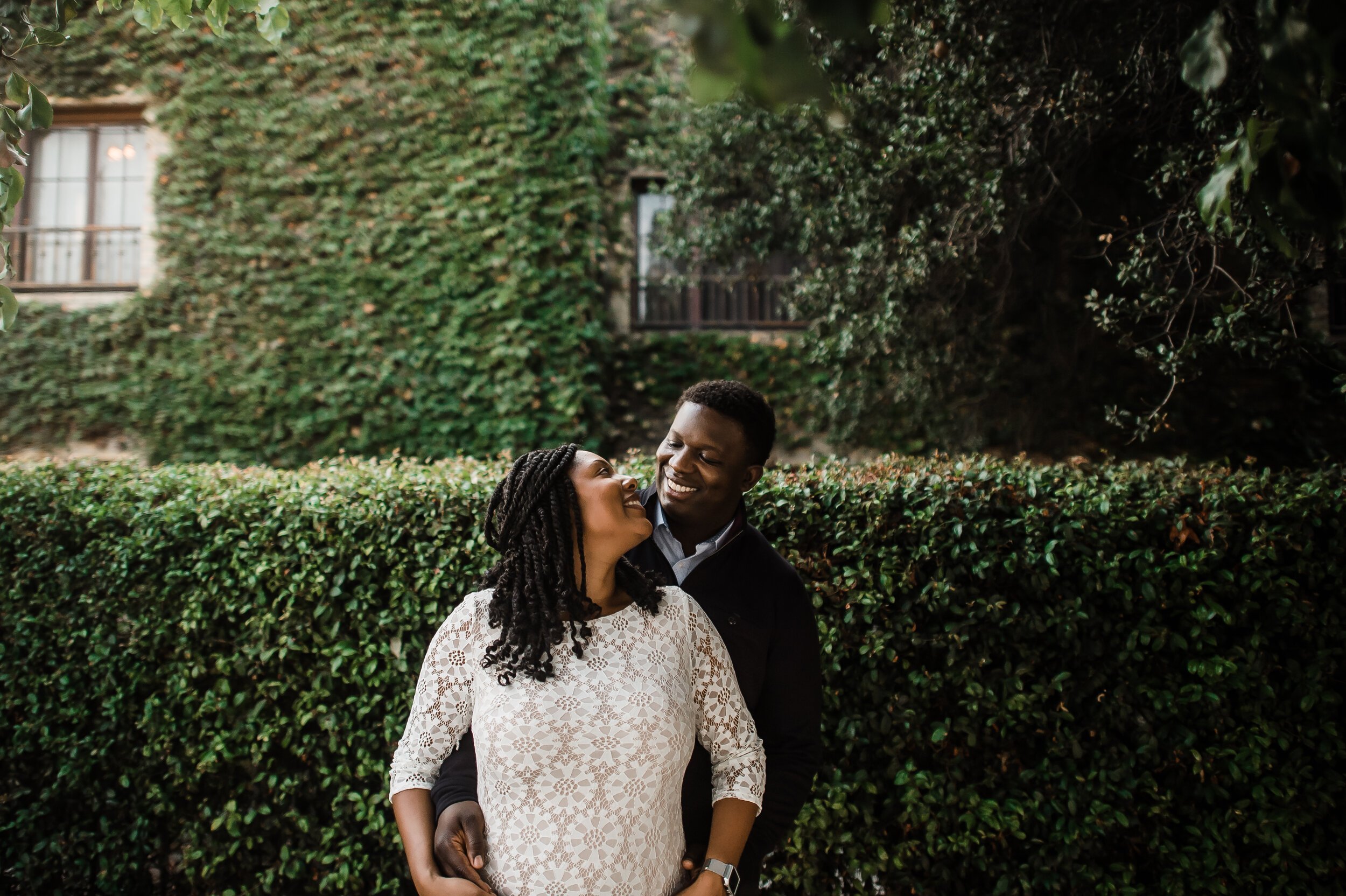 www.santabarbarawedding.com | Michelle Ramirez Photography | Couple Embraces in Front of Greenery During Engagement Shoot