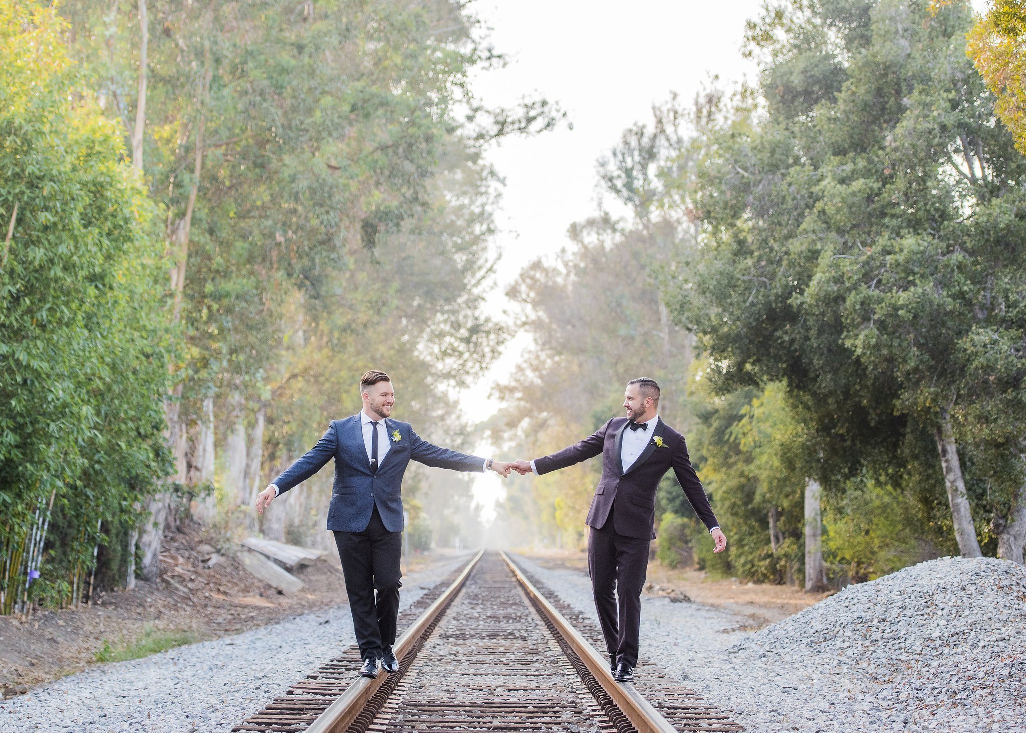 www.santabarbarawedding.com | Willa Kveta Photography | Pamela Galvin Events | Grooms Hold Hands Over Railroad Tracks