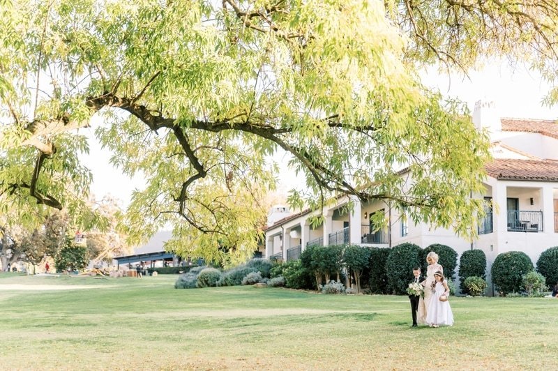 www.santabarbarawedding.com | Ojai Valley Inn | White Sage | Ellie Koleen Photography | Ojala Floral | Ivory Bridal Boutique | Rogue Styling | Bride Walking Into Ceremony with Daughter and Son